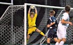 Breck goalkeeper Hudson Haecker makes a leaping save.