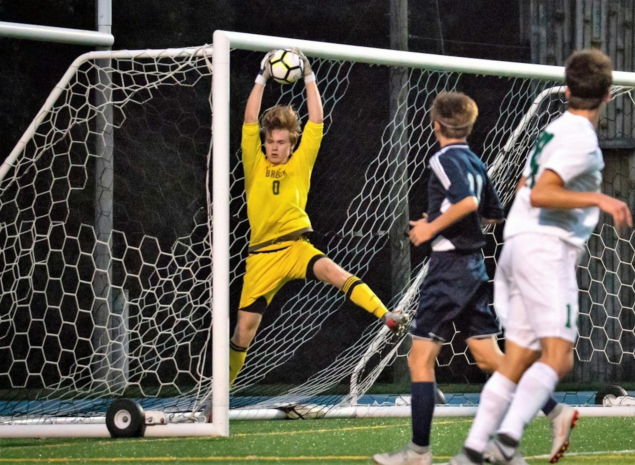 Breck goalkeeper Hudson Haecker makes a leaping save.