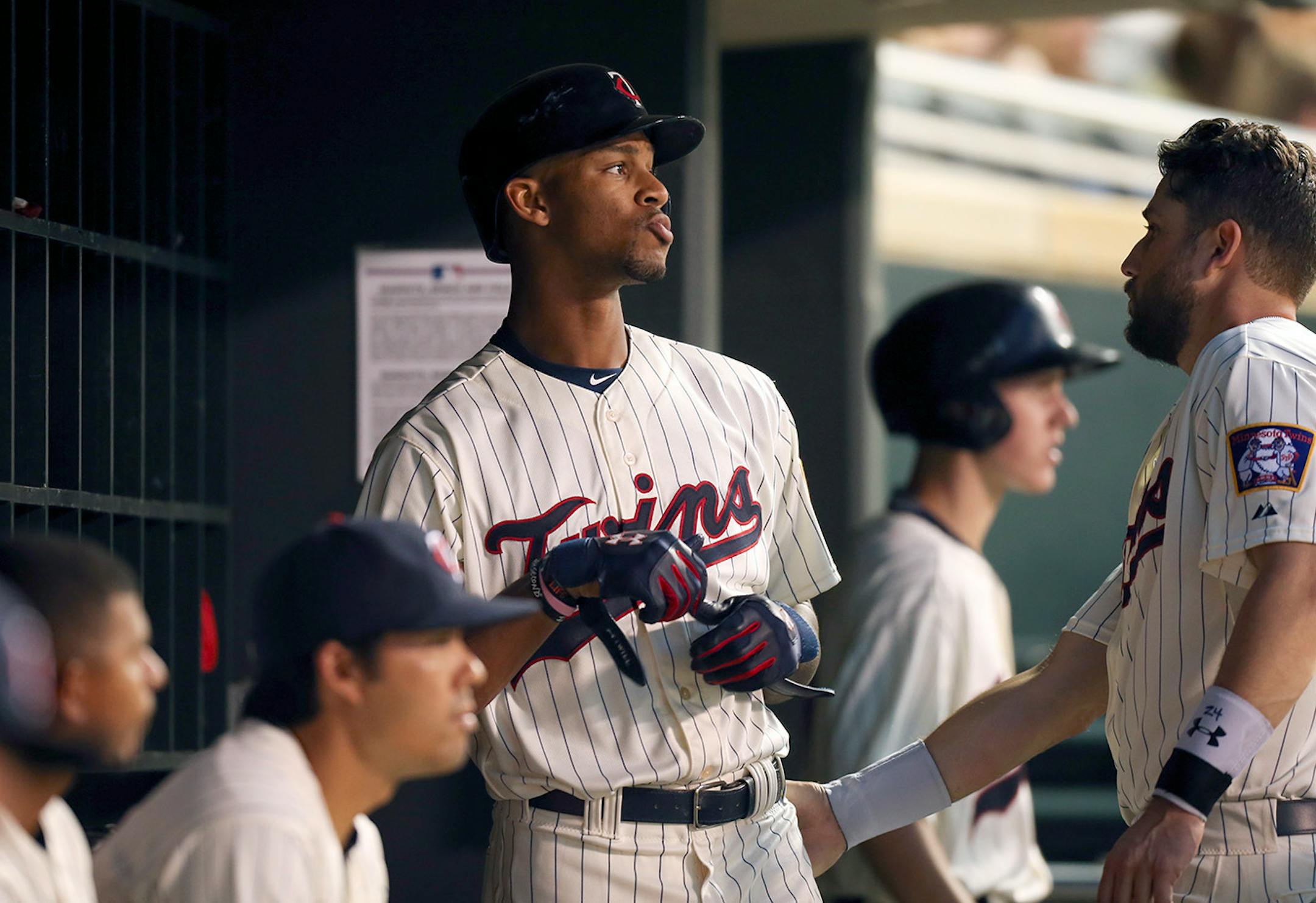 Twins center fielder Byron Buxton took off his batting gloves after he struck out swinging during a game last June.