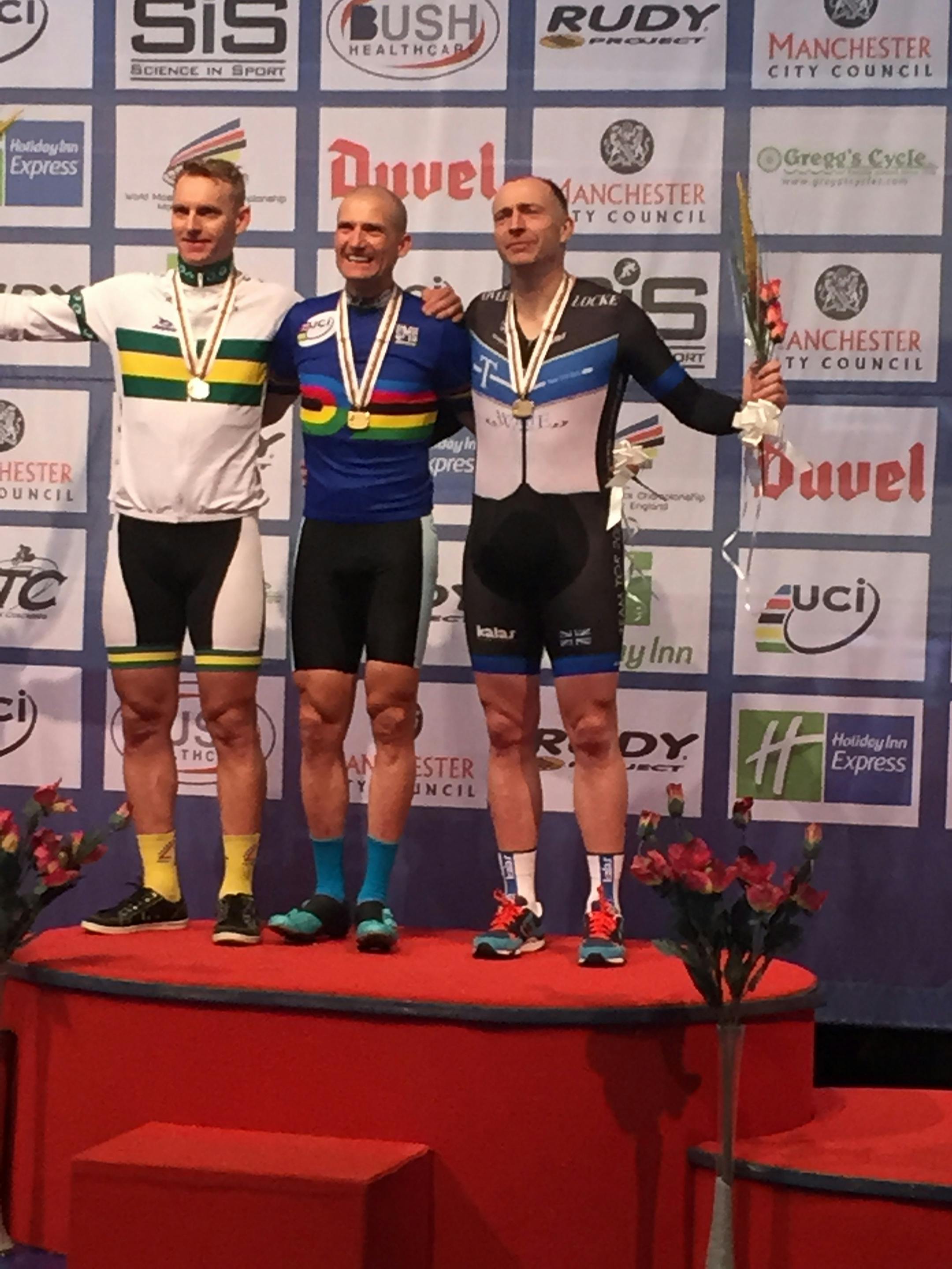 Daniel Casper, center, first-place finisher in the men's 45-49 individual pursuit at the Master's World Championship, is joined by the second and third place finishers on the podium.