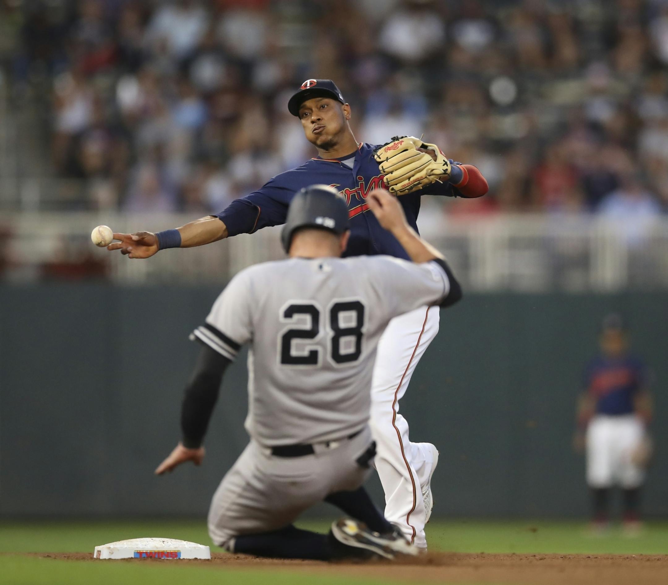 Minnesota Twins shortstop Jorge Polanco (11) threw to first to try to complete a fourth inning double play after forcing out Yankees catcher Austin Romine (28) on a grounder by D.J. LeMahieu.