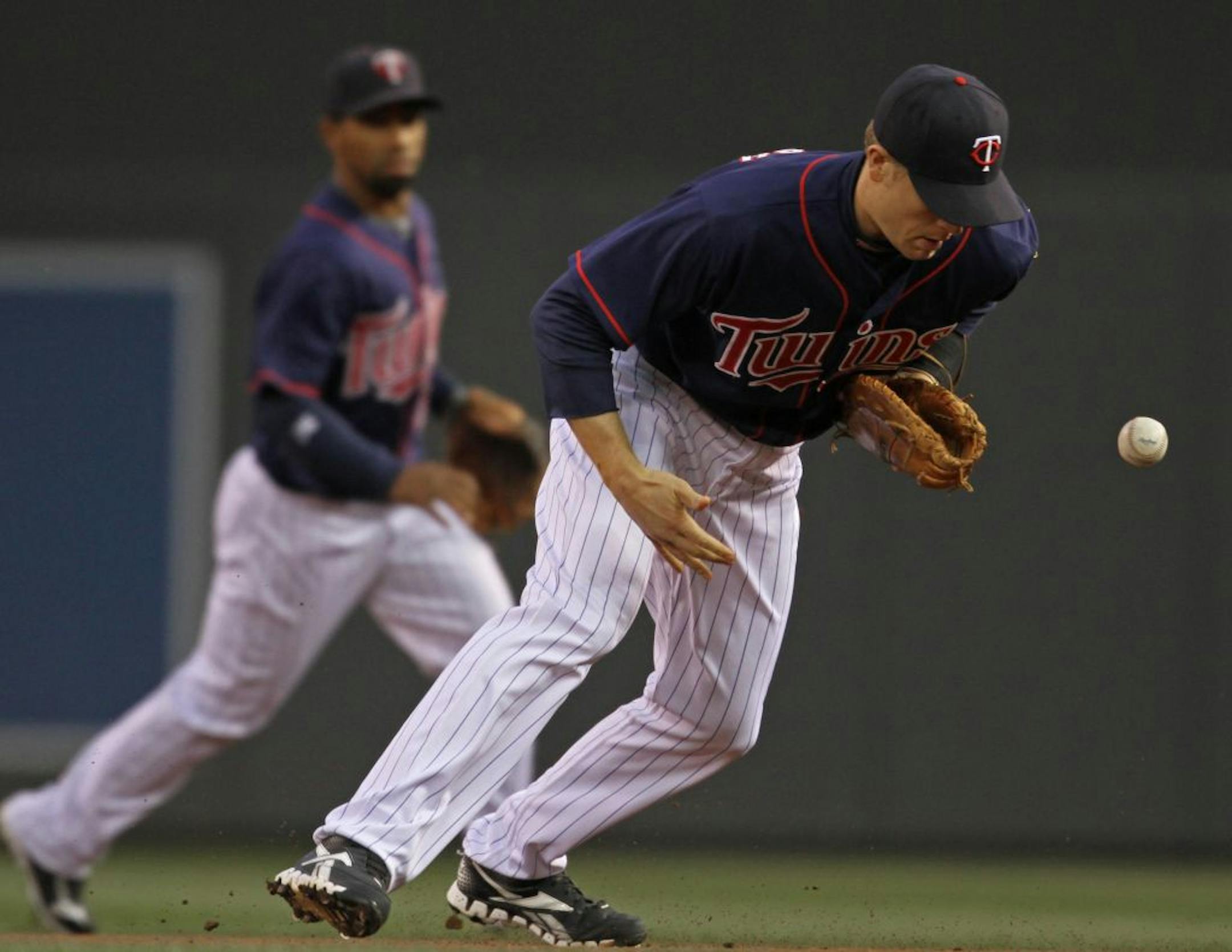 Minnesota Twins vs. Kansas City Royals, 4/27/12. (left to right) Twins Justin Morneau bobbled a drive by Jarrod Dyson for an error in the first inning. Dyson was safe at first.