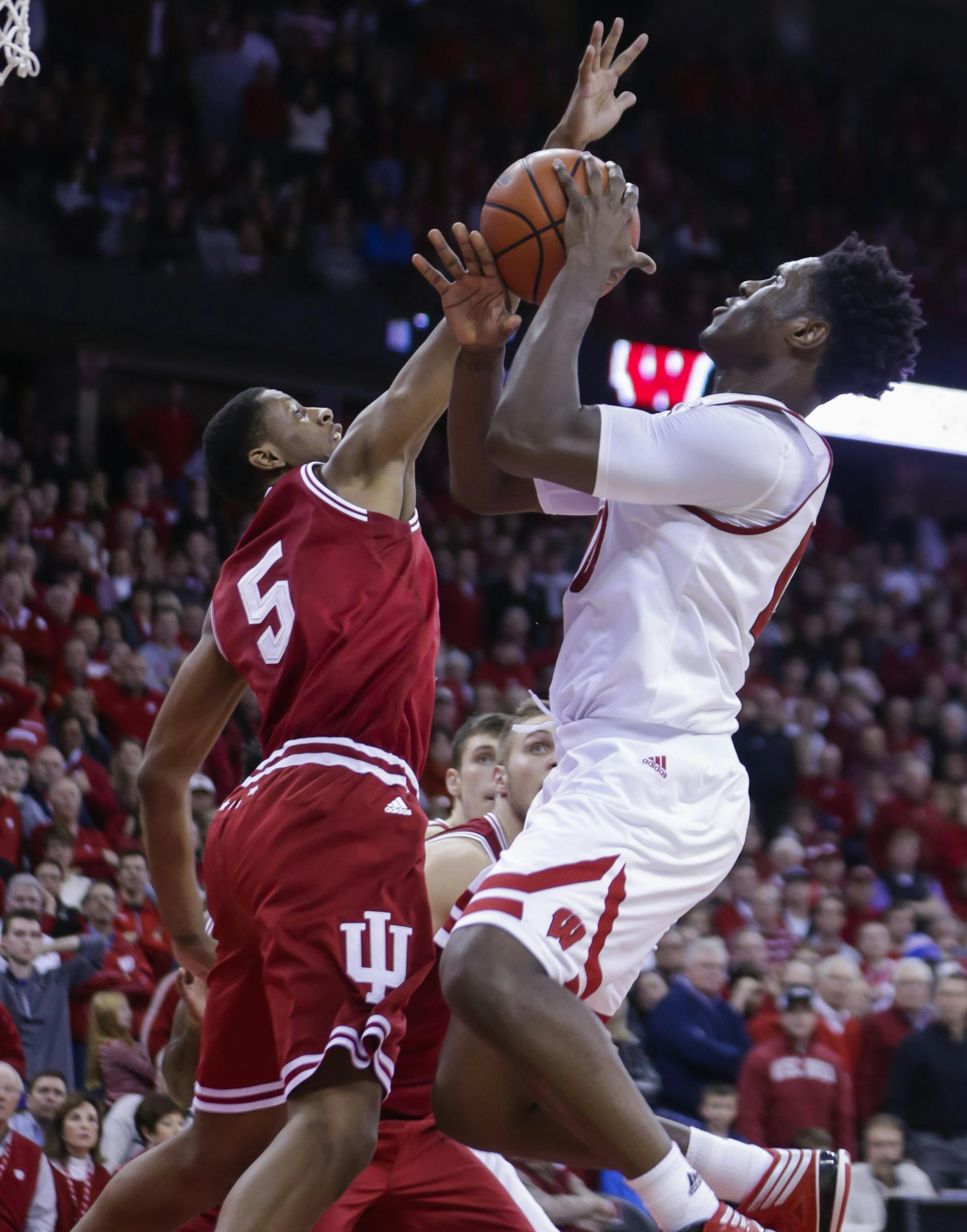Wisconsin's Nigel Hayes, right, shoots against Indiana's Troy Williams (5) during the second half of an NCAA college basketball game Tuesday, Jan. 26, 2016, in Madison, Wis. Hayes had a game-high 31 points in Wisconsin's 82-79 overtime win. (AP Photo/Andy Manis)