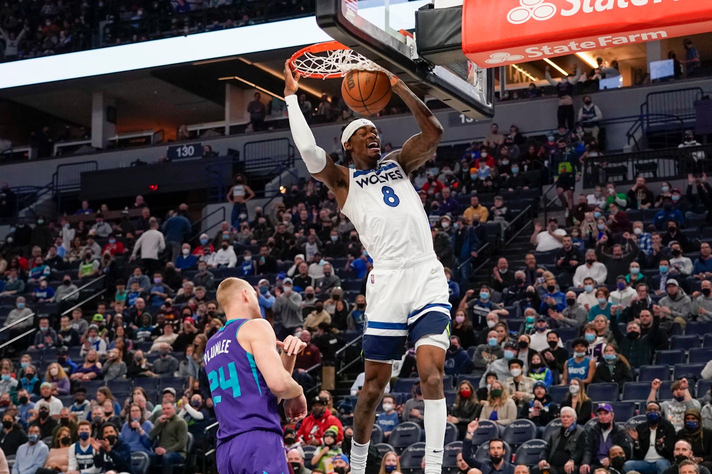 Minnesota Timberwolves forward Jarred Vanderbilt (8) dunks after driving past Charlotte Hornets center Mason Plumlee (24) during the first half of an NBA basketball game Tuesday, Feb. 15 2022, in Minneapolis. (AP Photo/Craig Lassig)