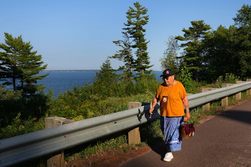 Ojibwe elder Sharon Day leads a Nibi Water Walk around Lake Superior Wednesday, Aug. 2, 2023 near Washburn, Wis. The ceremony is meant to encourage the water's health and express gratitude. The walkers take turns carrying a small pail of water, affixed with a GPS unit so people can track its progress online, and another a sacred staff, traveling in silence, prayer, or song.  ] ANTHONY SOUFFLE • anthony.souffle@startribune.com