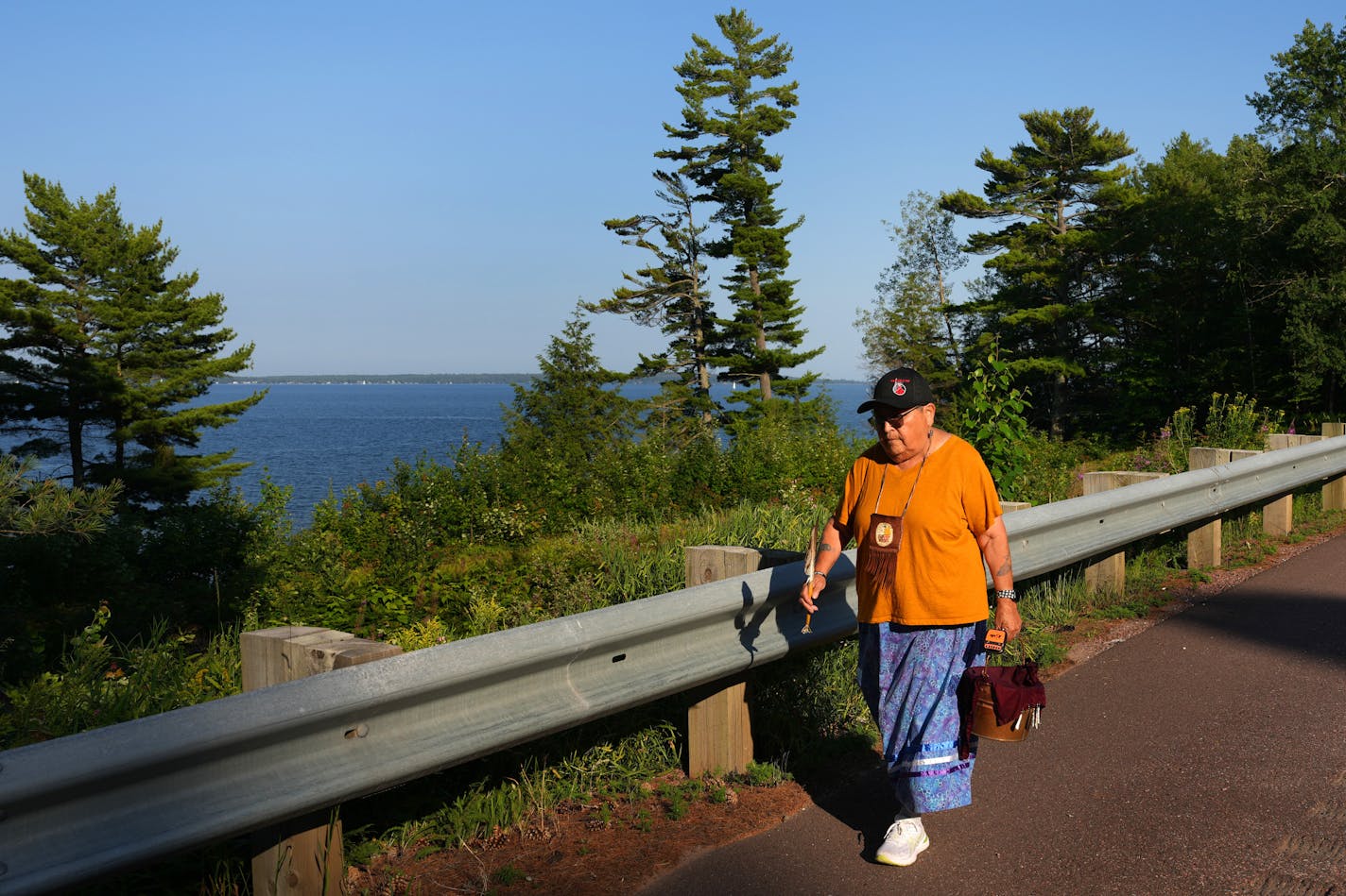 Ojibwe elder Sharon Day leads a Nibi Water Walk around Lake Superior Wednesday, Aug. 2, 2023 near Washburn, Wis. The ceremony is meant to encourage the water's health and express gratitude. The walkers take turns carrying a small pail of water, affixed with a GPS unit so people can track its progress online, and another a sacred staff, traveling in silence, prayer, or song.  ] ANTHONY SOUFFLE • anthony.souffle@startribune.com