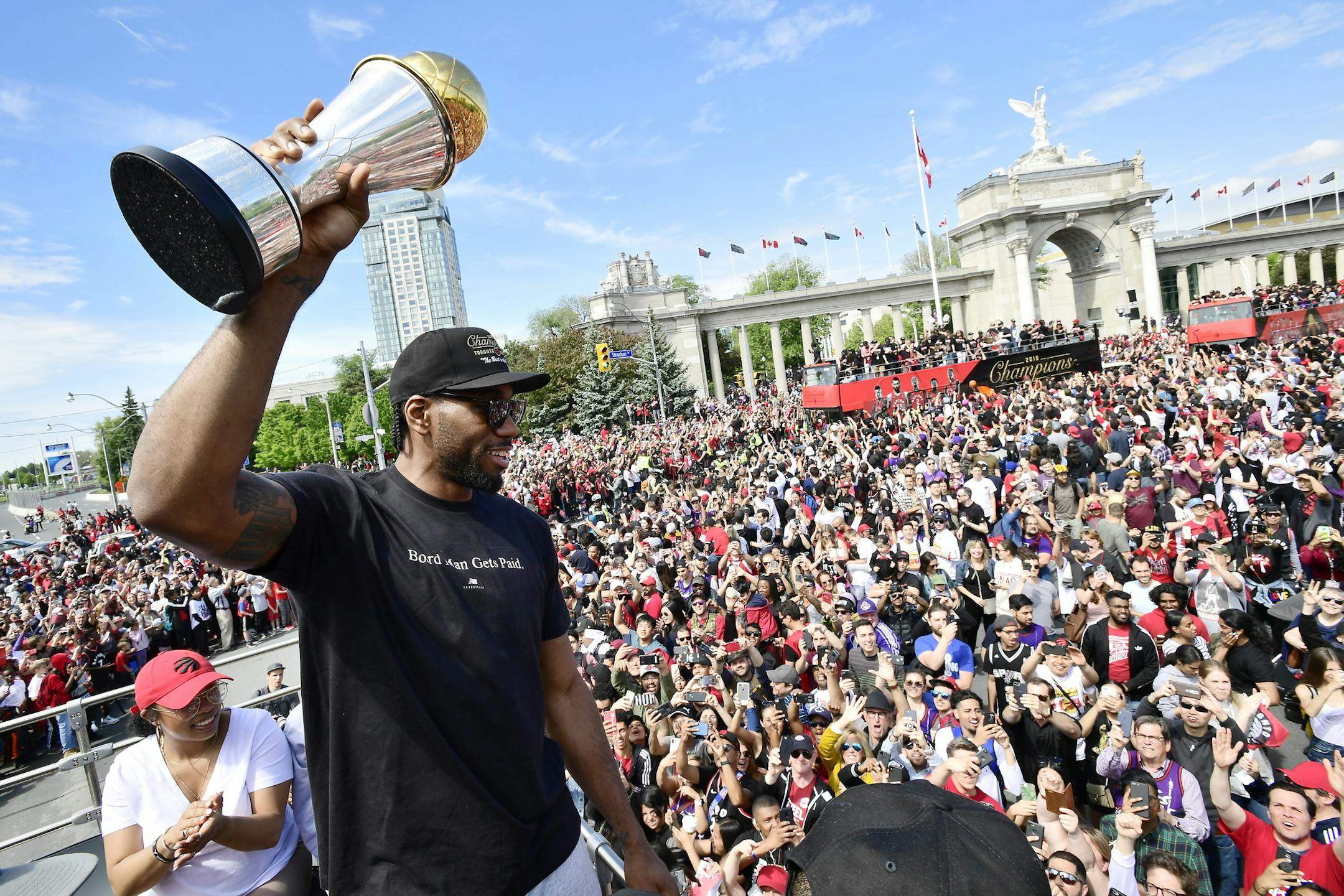 Toronto Raptors forward Kawhi Leonard holds his playoffs MVP trophy during the NBA basketball championship team's victory parade in Toronto, Monday, June 17, 2019. (Frank Gunn/The Canadian Press via AP)