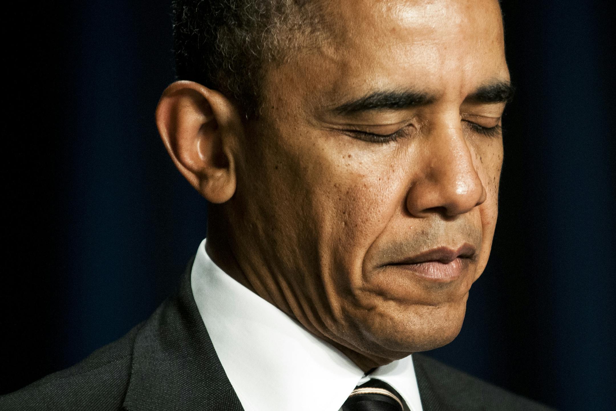President Barack Obama bows his head in prayer during the annual National Prayer Breakfast in Washington, Feb. 6, 2014.
