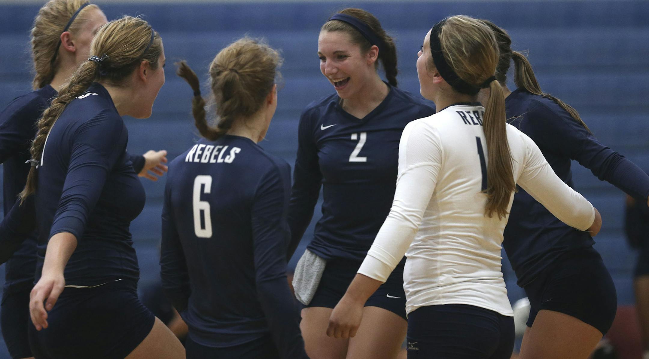 Sydney Hilley, freshman volleyball player at Champlin Park celebrated with her teammates after they scored during their first set against Roseville High School in Roseville, Min., Tuesday, August 27, 2013. ] (KYNDELL HARKNESS/STAR TRIBUNE) kyndell.harkness@startribune.com