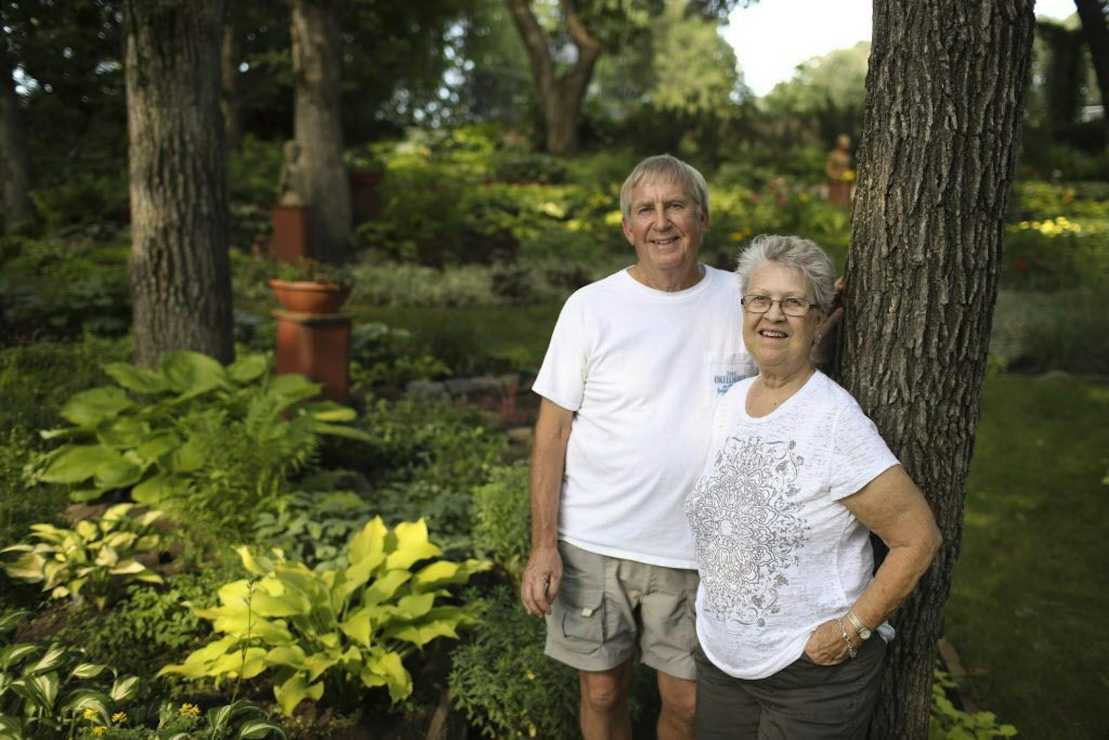 Gene and Lois Waldowski in their garden. He's a retired teacher who combines art and math to create a well-composed garden.
