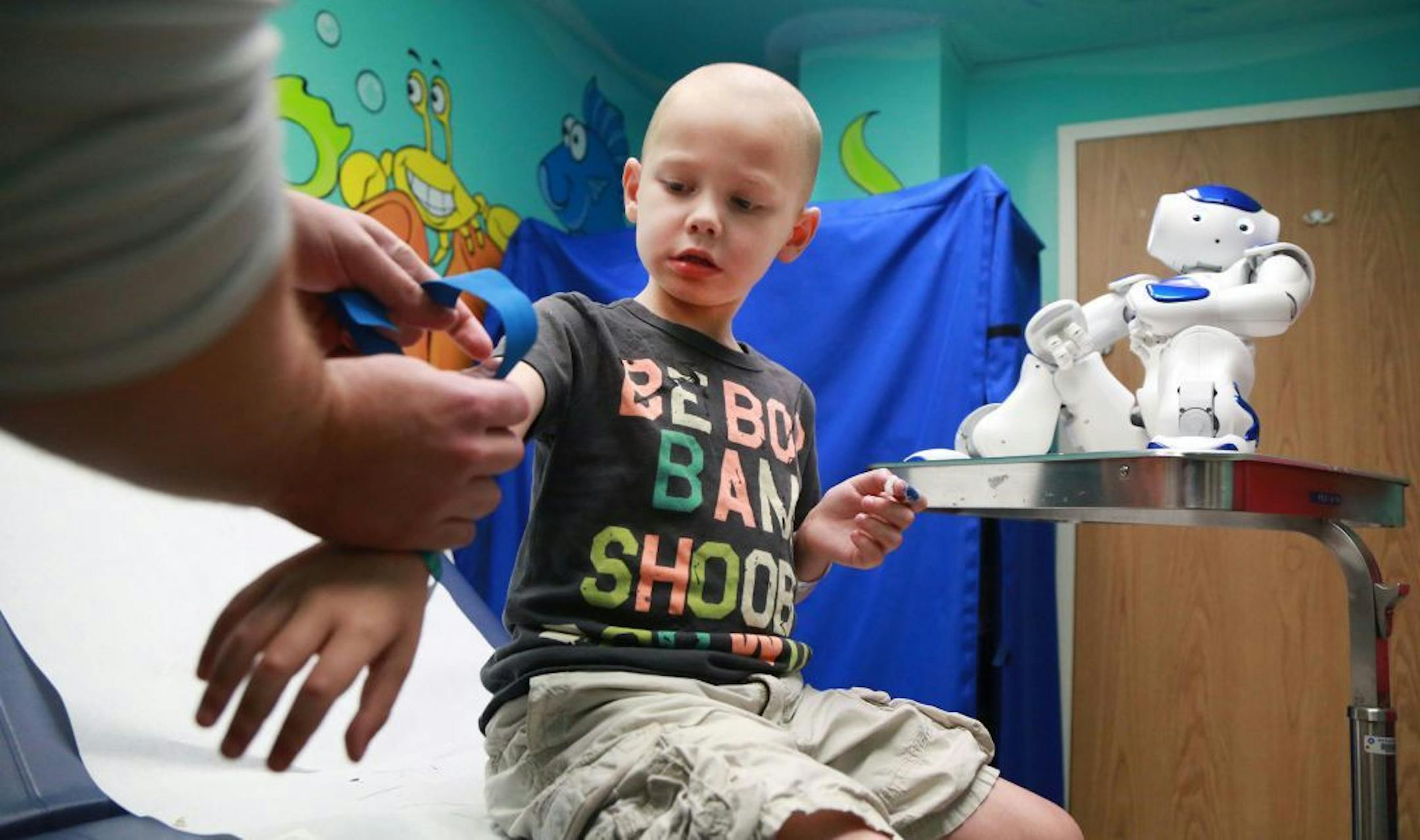 Tommy Boegler, 4, of Tamarac, Fla. with MEDi at his side during a visit to Broward Health. The hospital is one of eight hospitals nationwide using a child-friendly robot named MEDi to help the littlest patients overcome the anxiety and fear associated with most medical procedures.
