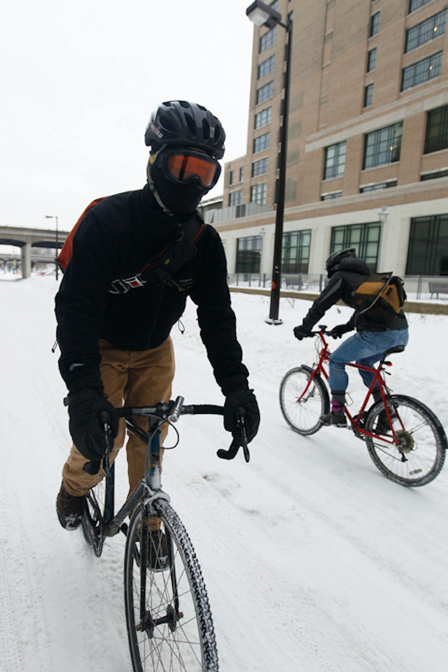 Using the Midtown Greenway in Minneapolis, Daniel Kutschied (foreground) rides 5 miles each way to work, but figures it saves him time because "I do not have to find an hour in the day to go work out."