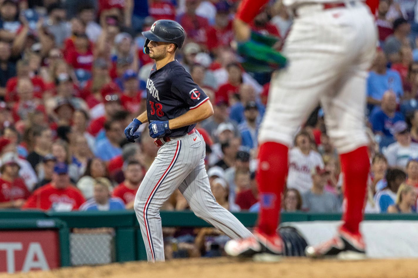 Minnesota Twins' Matt Wallner (38) runs the bases past Philadelphia Phillies starting pitcher Taijuan Walker after hitting a home run during the fourth inning of a baseball game, Saturday, Aug. 12, 2023, in Philadelphia. (AP Photo/Laurence Kesterson)