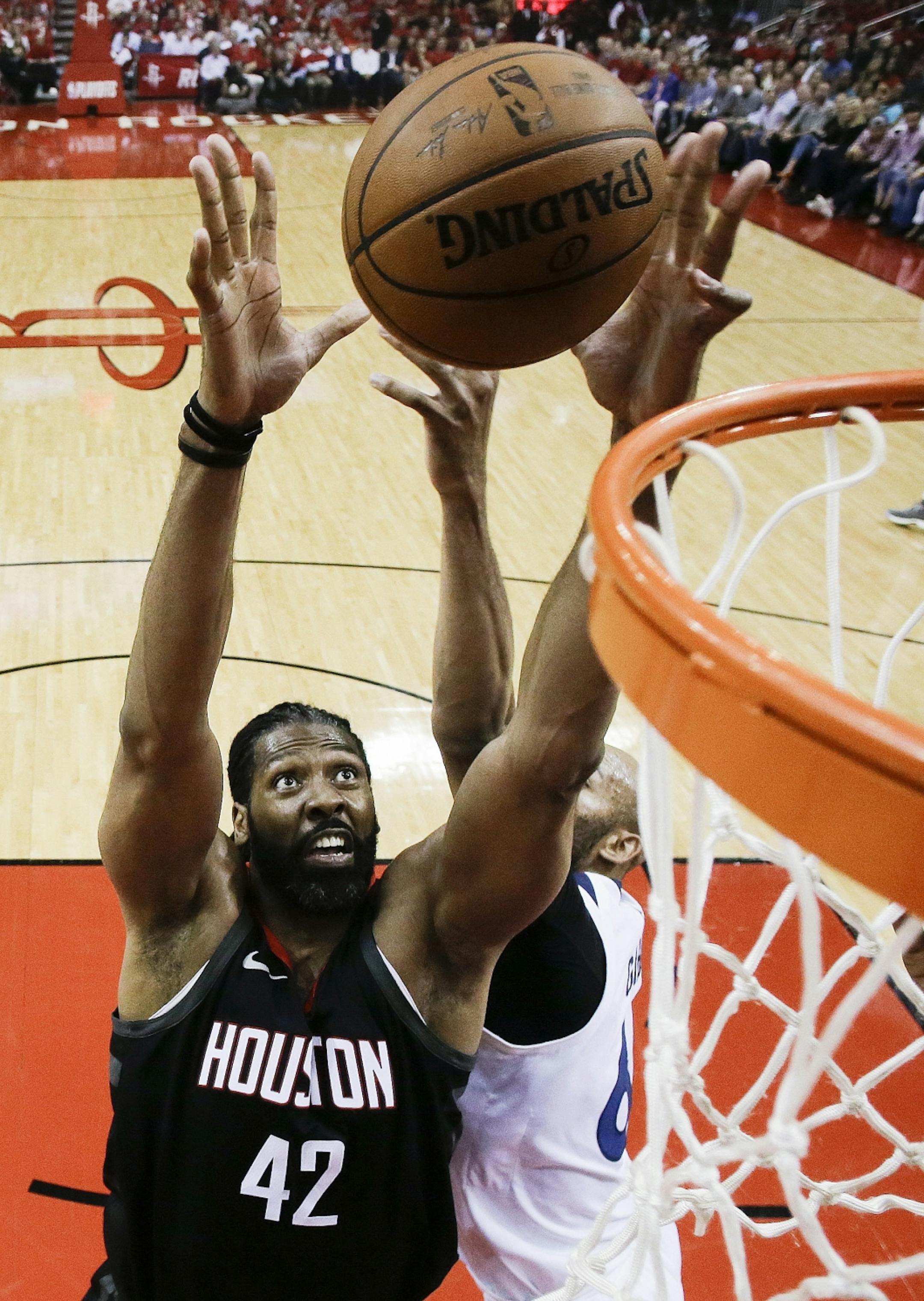 Houston Rockets center Nene (42) and Minnesota Timberwolves forward Taj Gibson vie for a rebound during the first half in Game 5 of a first-round NBA basketball playoff series Wednesday, April 25, 2018, in Houston.