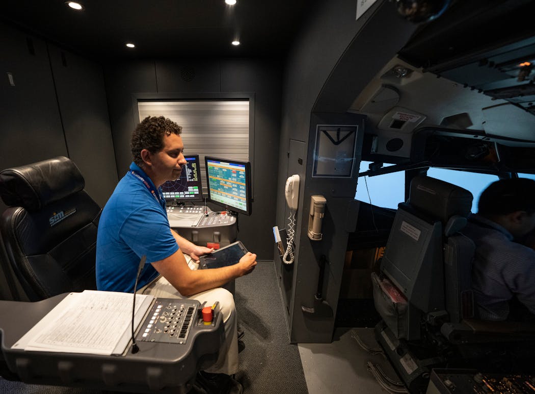 Flight instructor Capt. Chris VanderHorck gave instructions to two new Sun Country pilots on a 737 flight simulator at the CAE Training Center in Eagan earlier this month.