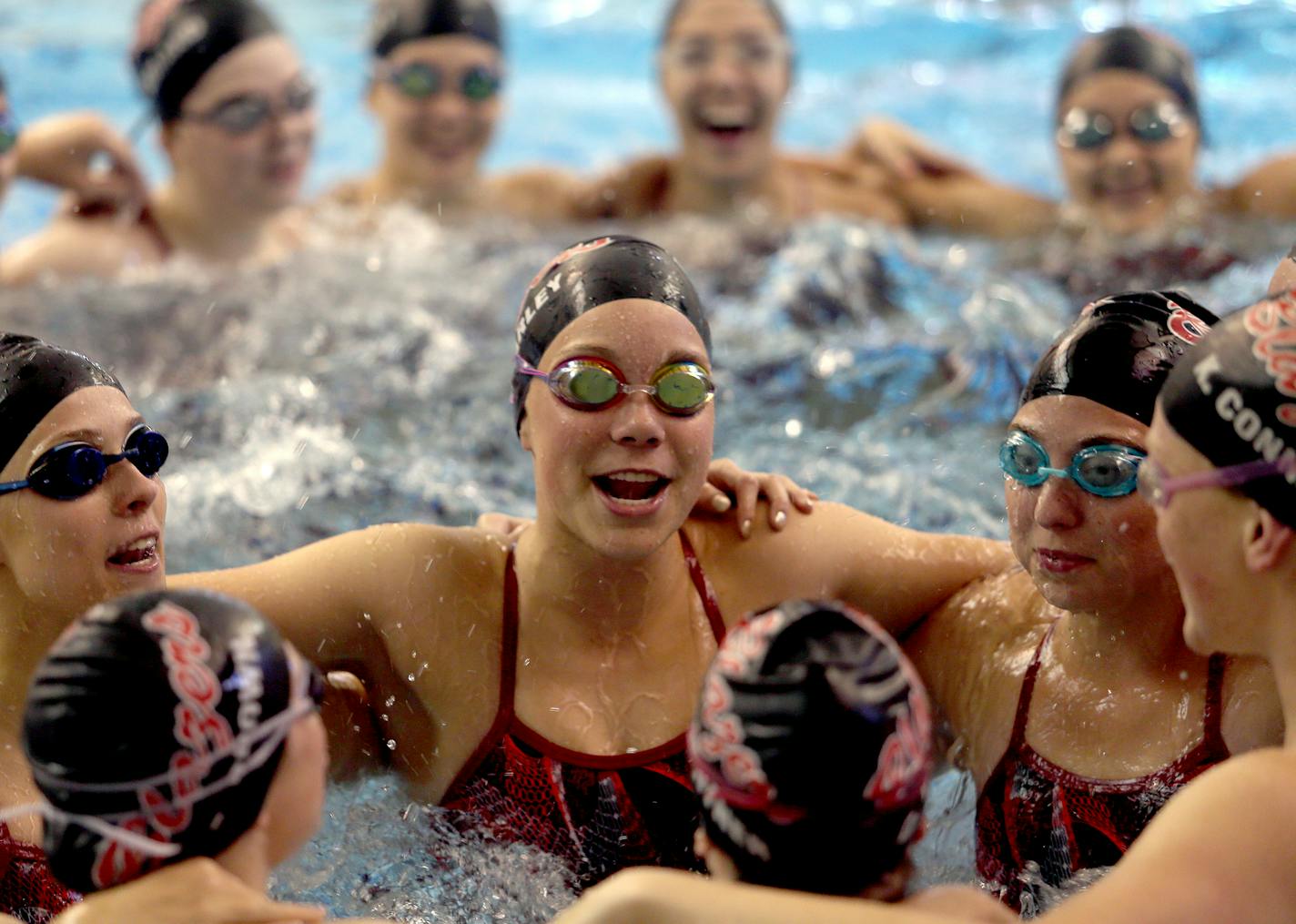 Visitation swimmer Heather Farley (center) with her teammates at St. Kate's University in St. Paul