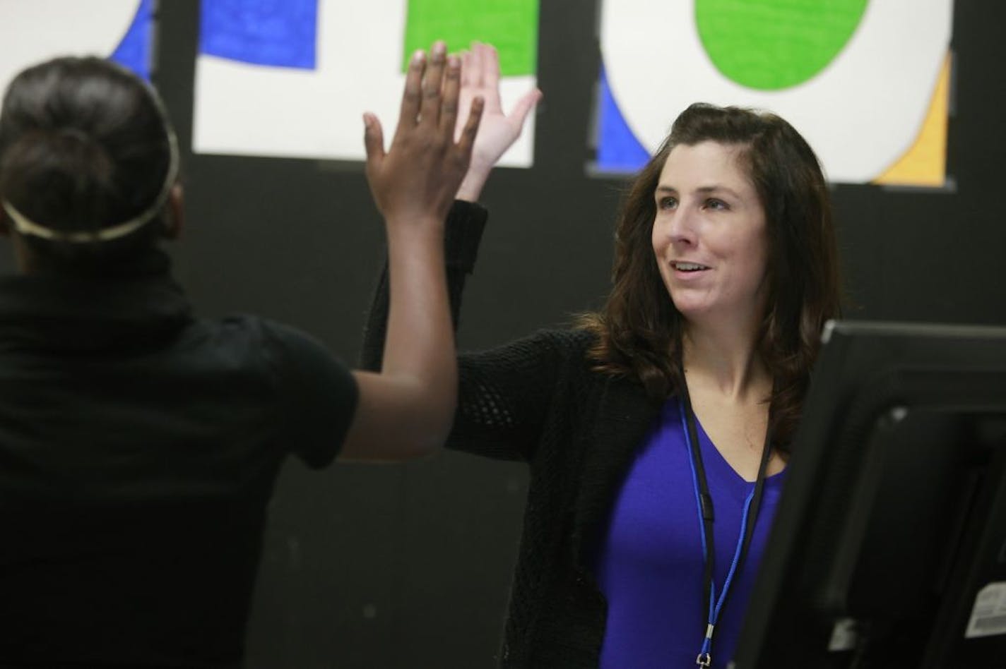 Radio instructor Heather Kraabel gave a high-five to student Keyonna Green, 14, after discussing her grades at North High School.