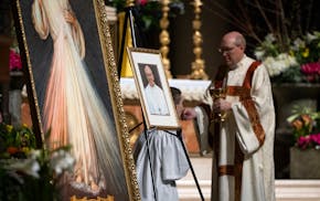 A portrait of Pope Francis is displayed during Mass at the Cathedral of St. Paul on April 21. Francis died earlier that day.