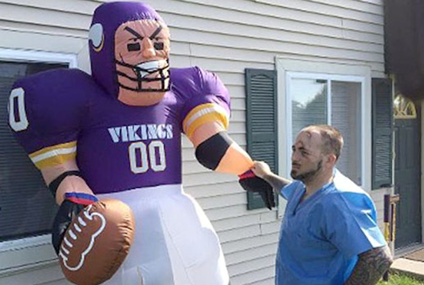 Dave Moschel of Stoughton, Wis., says he was sliced with a box cutter by a man who tried to cut up his Minnesota Vikings inflatable.