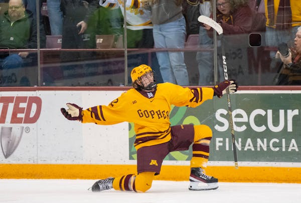 Gophers forward Logan Cooley celebrates scoring a goal against Wisconsin during a game in December.