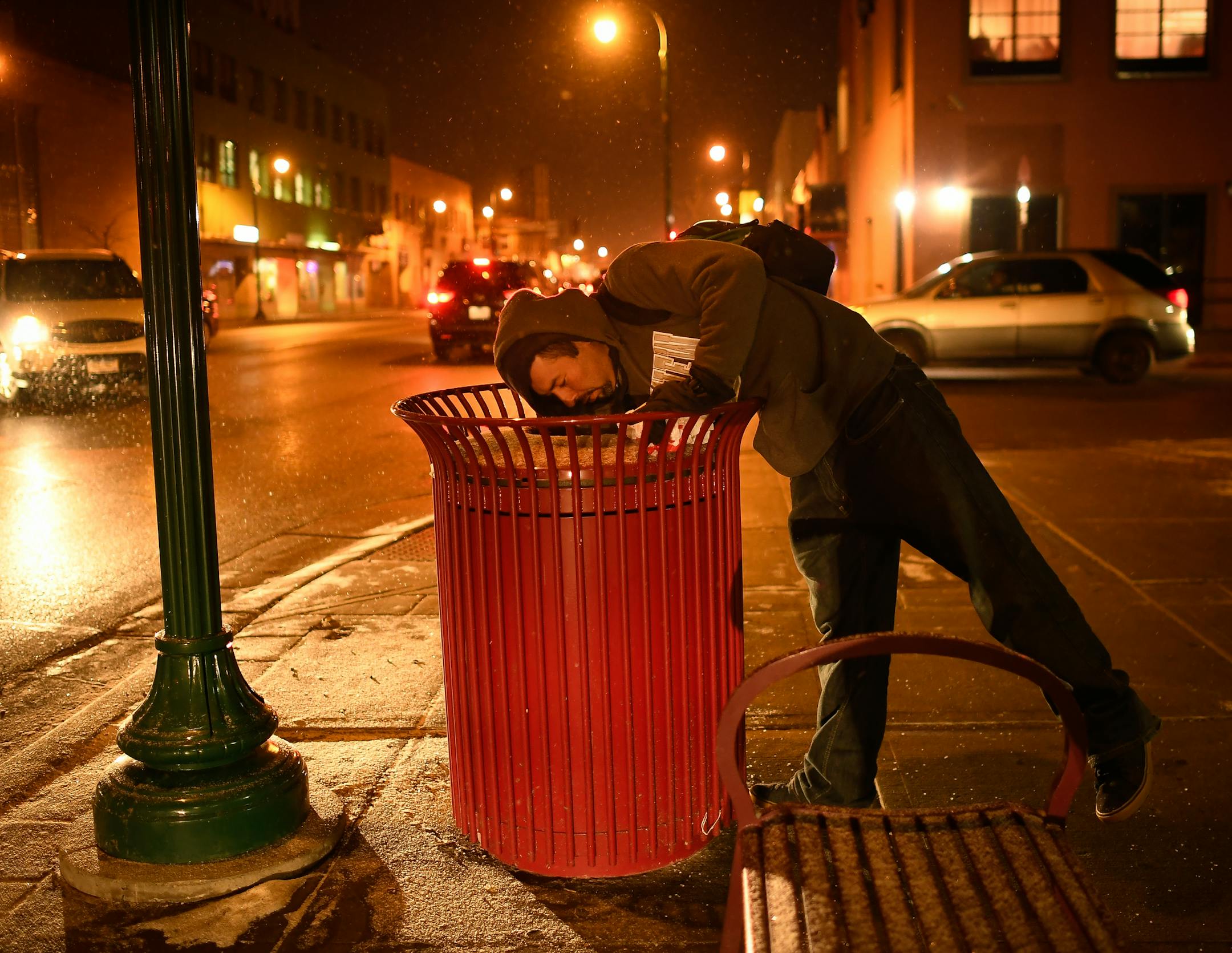 Dante Maldonado, a migrant from Guadalajara City, Mexico, reached into a trash can in search of food on E. Lake Street.