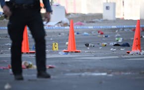 Police officers investigate the scene of a shooting where at least one person was killed and more than 20 others were injured after the Kansas City Ch