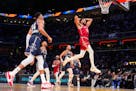 Timberwolves forward Karl-Anthony Towns dunked for two of his game-high 50 points during the first half of the East's 211-186 victory over the West in