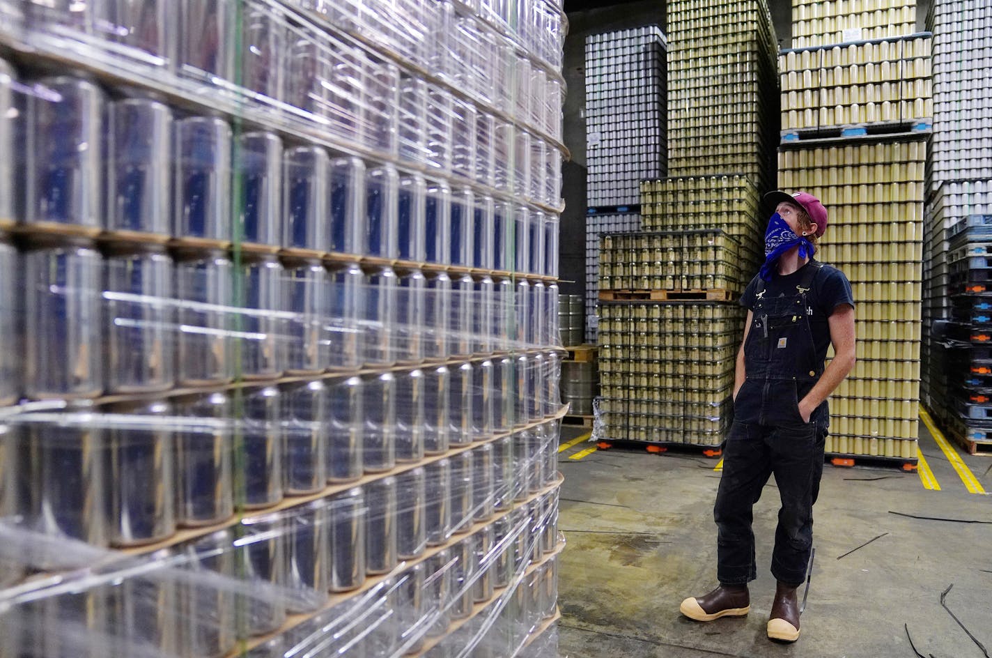 Mark Hines looked over the inventory of blank cans, including crowler cans, left, for Sociable Cider Werks on Thursday morning at an off-site warehouse in northeast Minneapolis.