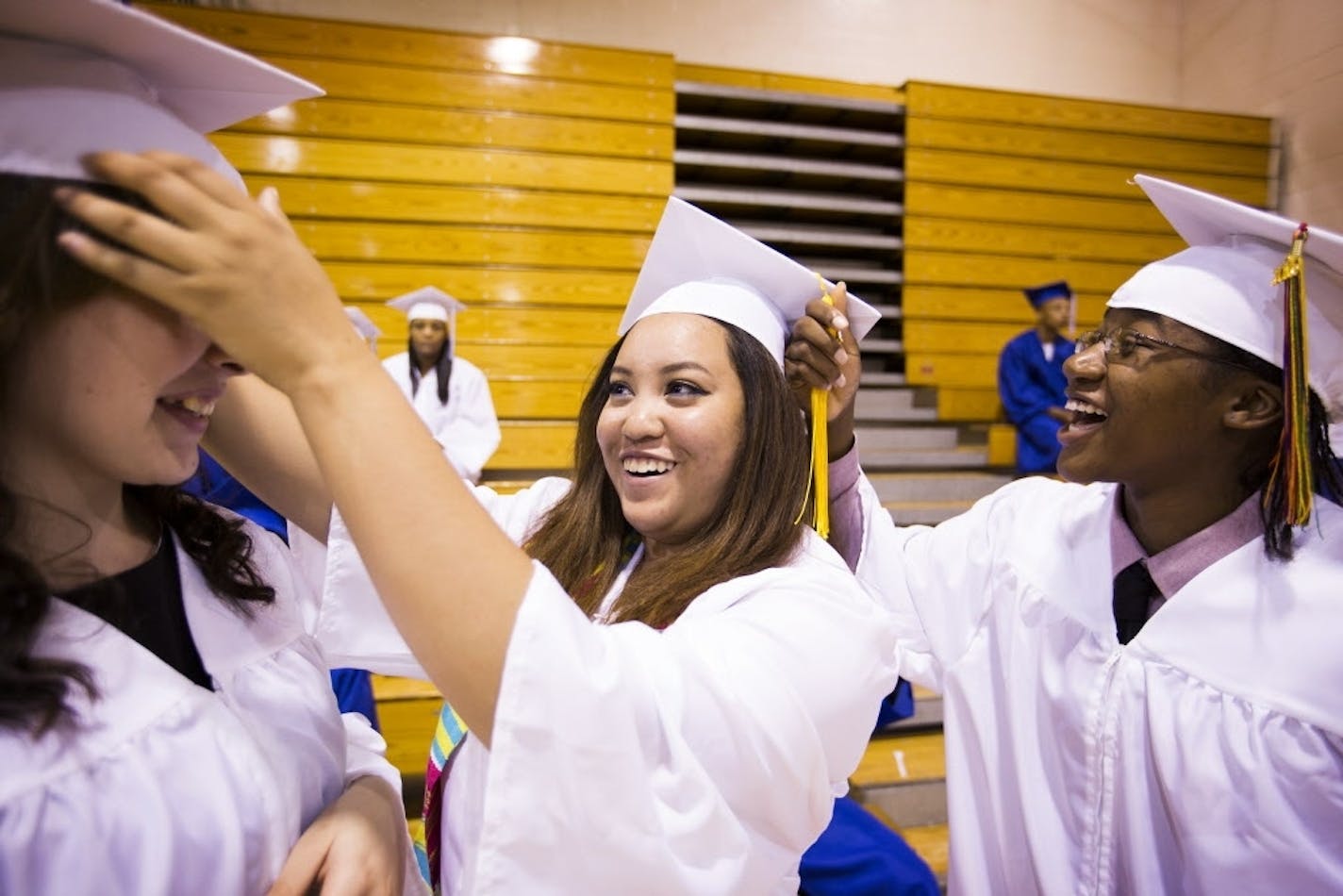 April McCann, from left, Thidasavanh "Rakel" Crockett and Ikea McGriff got ready for the North Community High School graduation ceremony in Minneapolis in June 2015.