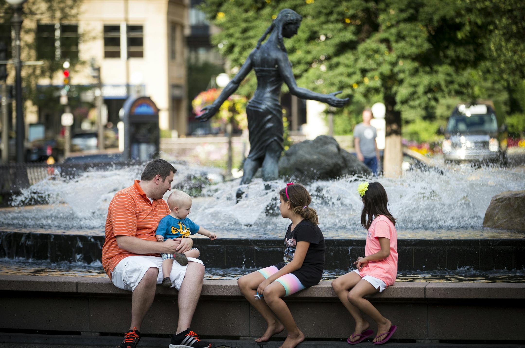 Chad Walsh sat at the fountain with his son Hudson Walsh and nieces Grace Slovik and Emily Slovik as they threw in pennies and made wishes at Rice Park on Monday, August 18, 2014 in St. Paul, Minn. His wife Amy (not pictured) and him brought the children to the park because Amy grew up coming here with her grandma and wanted to show it to the children. ] RENEE JONES SCHNEIDER • reneejones@startribune.com