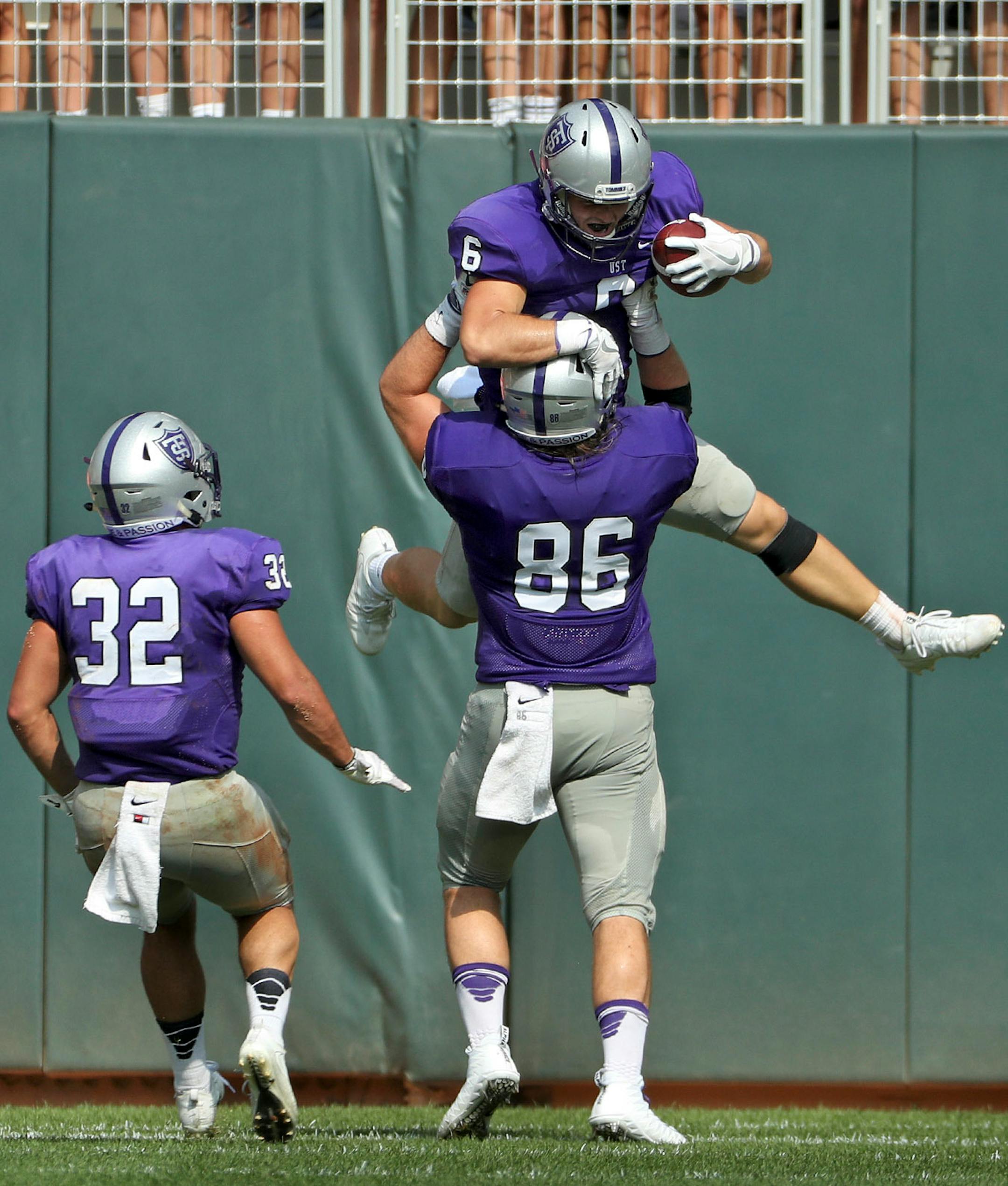 University of St. Thomas's Gabe Green (6) celebrated with University of St. Thomas tight end Matt Christenson (86) after scoring a touchdown in the first half.