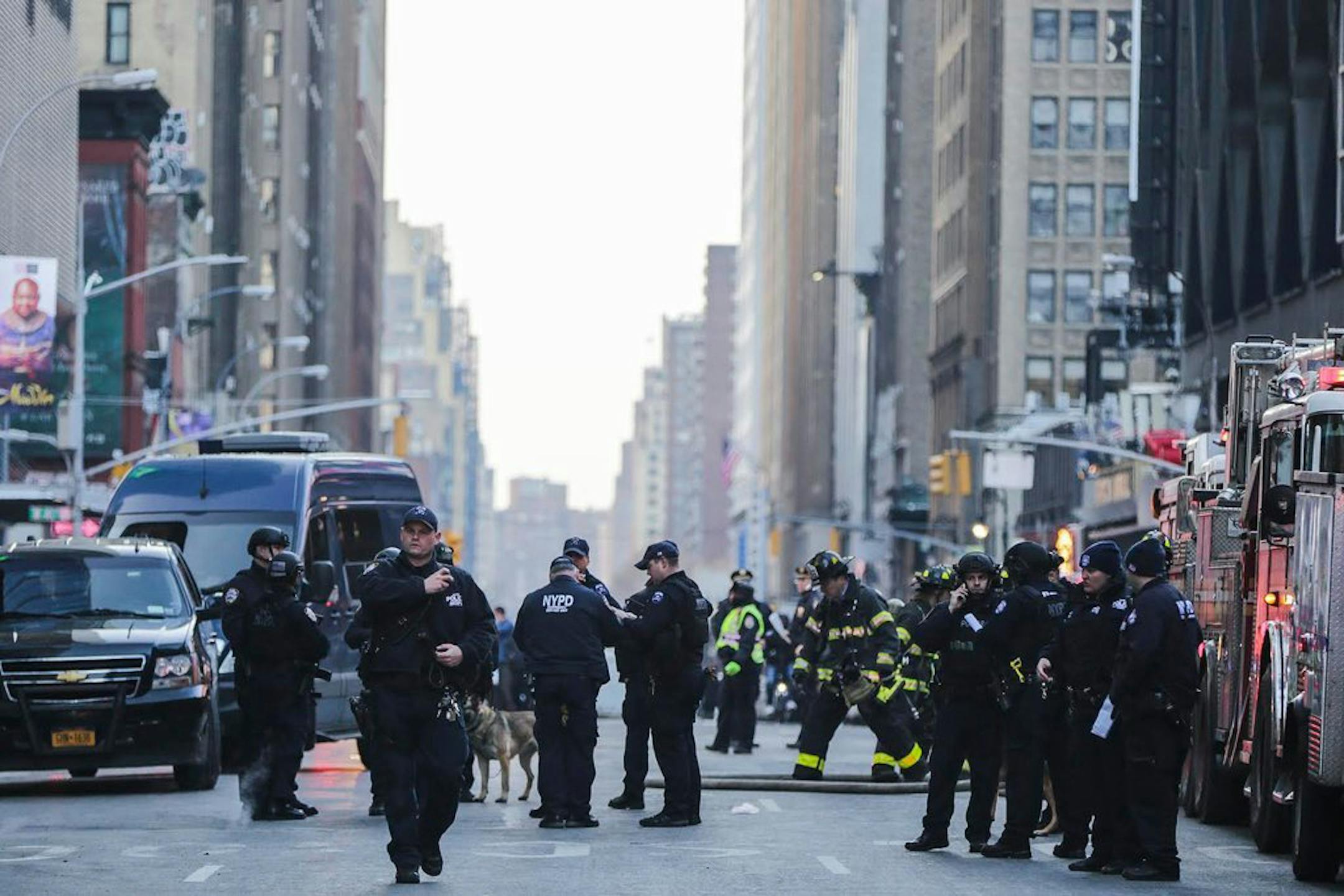 Police and firefighters on Eighth Avenue in New York following an explosion on Monday morning, Dec. 11, 2017. The explosion caused the authorities to evacuate one of the busiest transit hubs in the city as the workweek was set to begin. (Jeenah Moon/The New York Times)