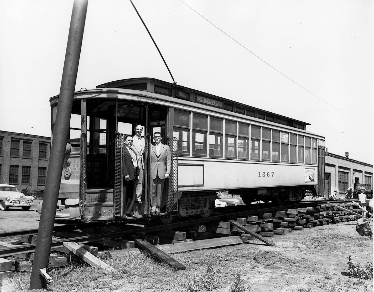 Car 1267 being loaded at the Snelling Shops on its way to Maine in 1953. Pictured from left to right are Twin Cities Rapid Transit (TCRT) General Manager, Barney Larrick, TCRT President Fred Ossanna, and Thomas Bergen of the Seashore Trolley Museum.