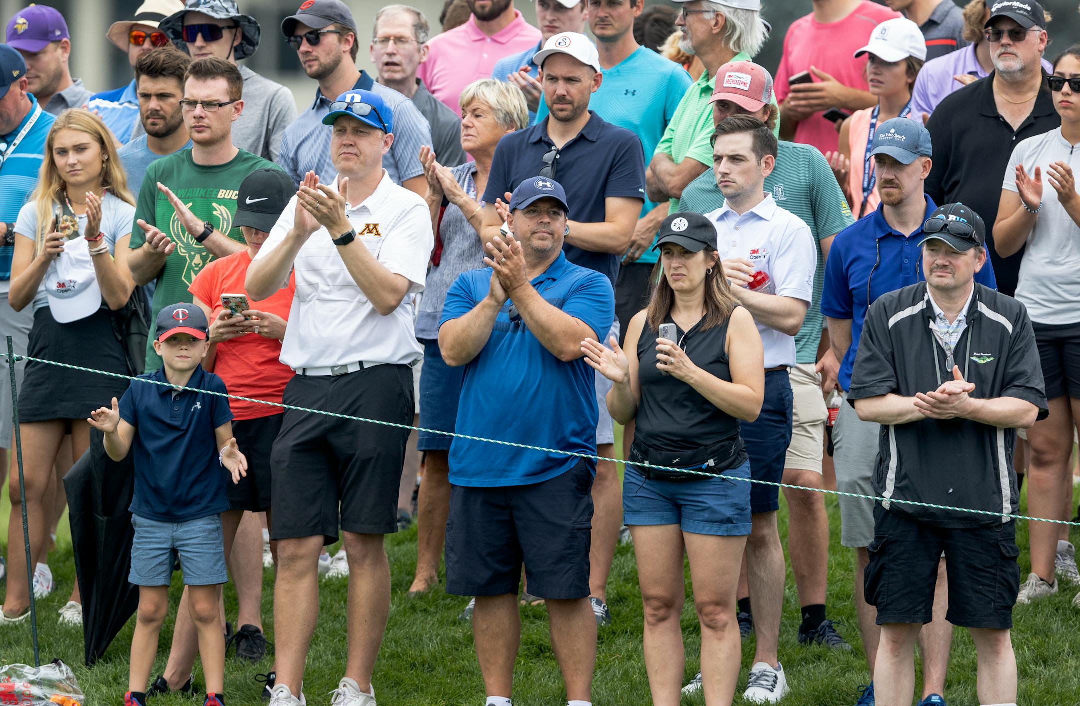 Fans on the 9th hole clapped after a successful putt during the first round of the 3M Open in Blaine.