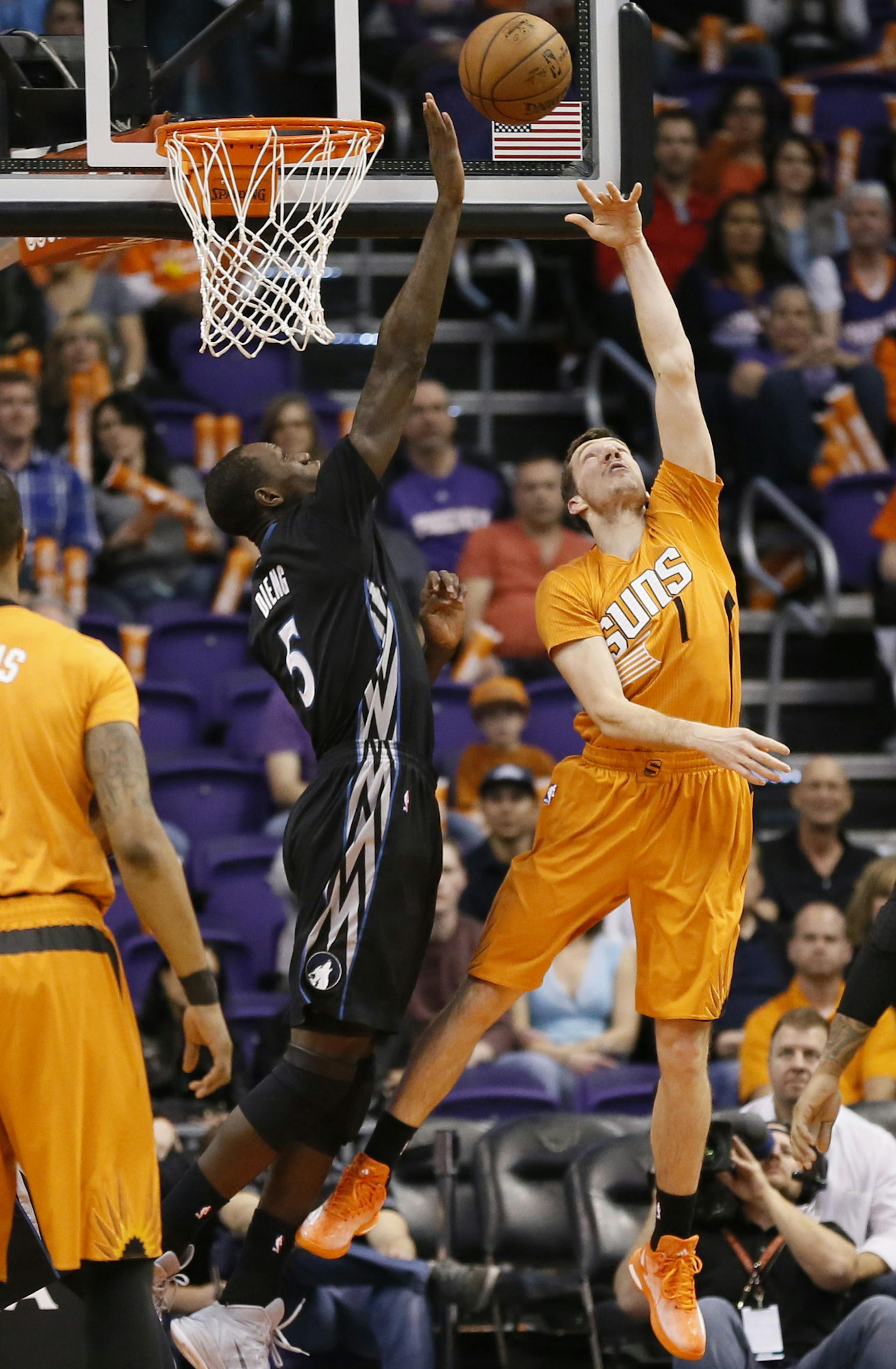 Minnesota Timberwolves' Gorgui Dieng (5), of Senegal, blocks the shot of Phoenix Suns' Goran Dragic (1), of Slovenia, during the first half of an NBA basketball game, Friday, Jan. 16, 2015, in Phoenix. (AP Photo/Matt York)