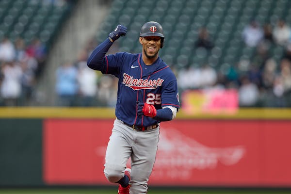 Minnesota Twins'. Byron Buxton rounds the bases after hitting a two-run home run off a pitch from Seattle Mariners starter Chris Flexen during the fir