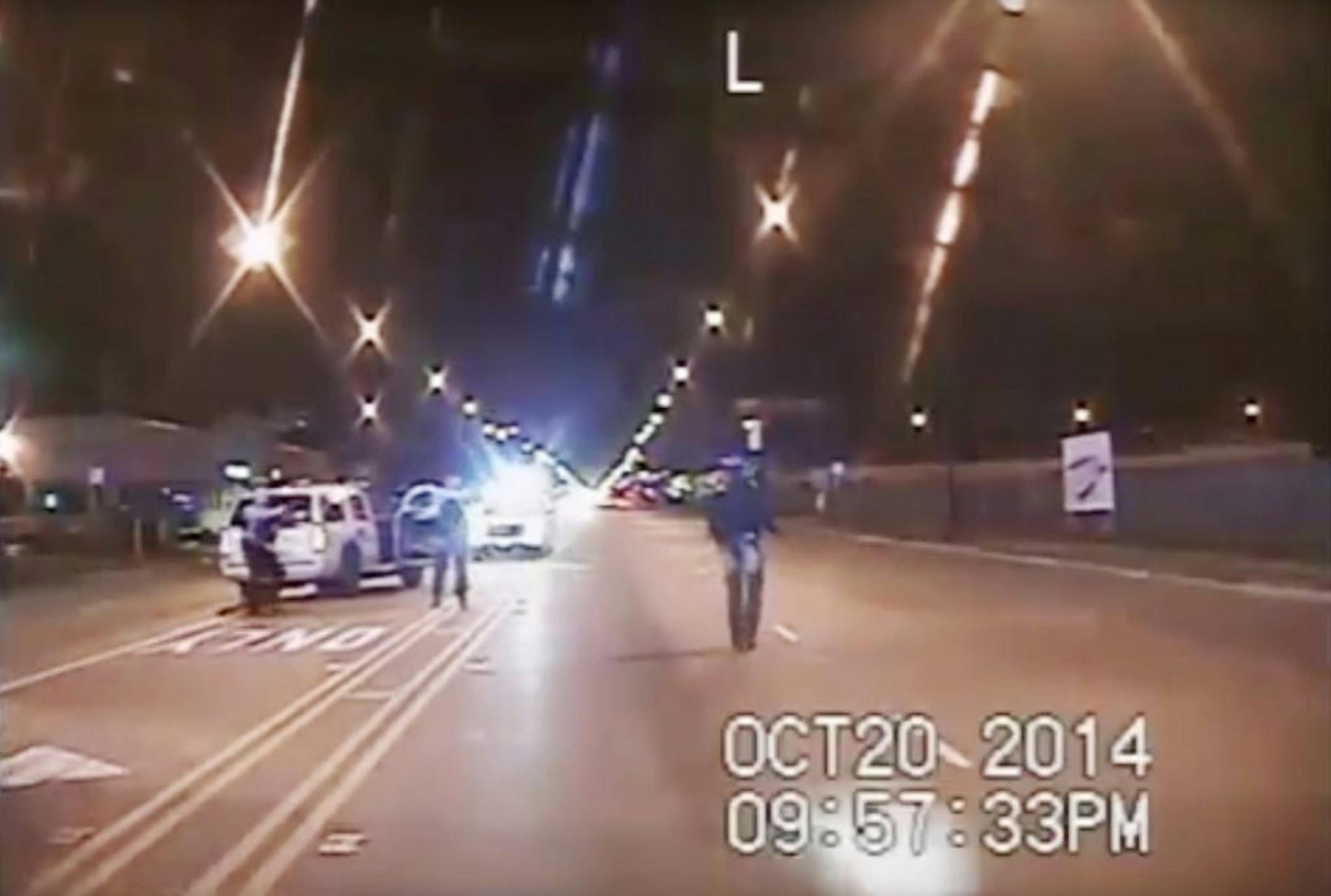 In this Oct. 20, 2014 frame from dash-cam video provided by the Chicago Police Department, Laquan McDonald, right, walks down the street moments before being shot by officer Jason Van Dyke in Chicago. Van Dyke, who shot McDonald 16 times, was charged with first-degree murder Tuesday, Nov. 24, 2015.