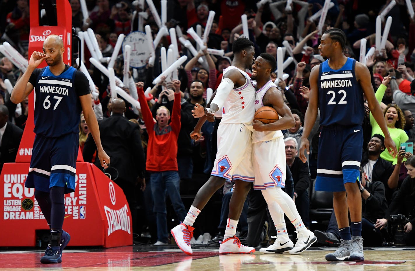 Bulls forward Bobby Portis, left, and guard David Nwaba right, celebrate as Timberwolves forwards Taj Gibson (67) and Andrew Wiggins (22) walk away at the end of Friday's game.