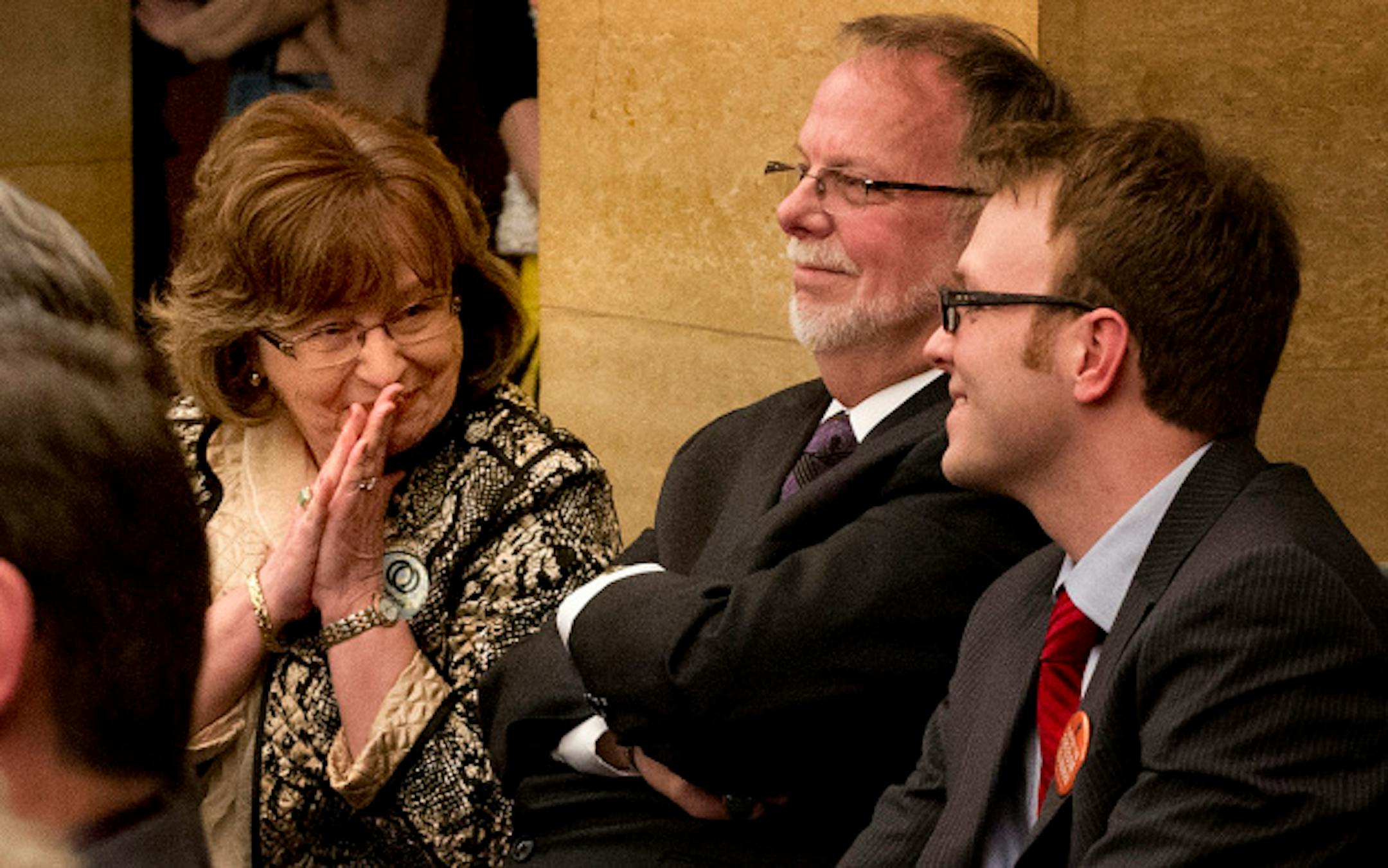Randi Reitan beamed a smile to her gay son Jacob after the bill passed.  She, her husband Phil, center, and son Jacob earlier asked the committee to please allow her son Jacob to be able to marry.   The Senate judiciary committee passed the same-sex marriage bill 5-3. Tuesday, March 12, 2013.    ]   GLEN STUBBE * gstubbe@startribune.com
