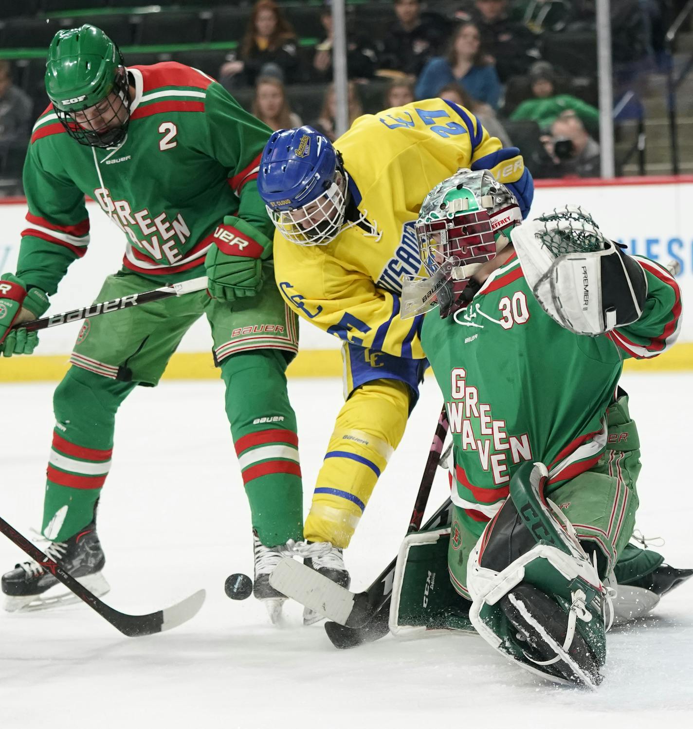 East Grand Forks goaltender Tucker Brown (30) keeps the puck away from the net as East Grand Forks defenseman Brandon Anderson (27) crowds him and East Grand Forks defenseman Luke Vonesh (2) defends during the first period. ] LEILA NAVIDI &#xa5; leila.navidi@startribune.com BACKGROUND INFORMATION: St. Cloud Cathedral plays against East Grand Forks in a Class 1A boys' hockey semifinal game at the Xcel Energy Center in St. Paul on Friday, March 8, 2019.