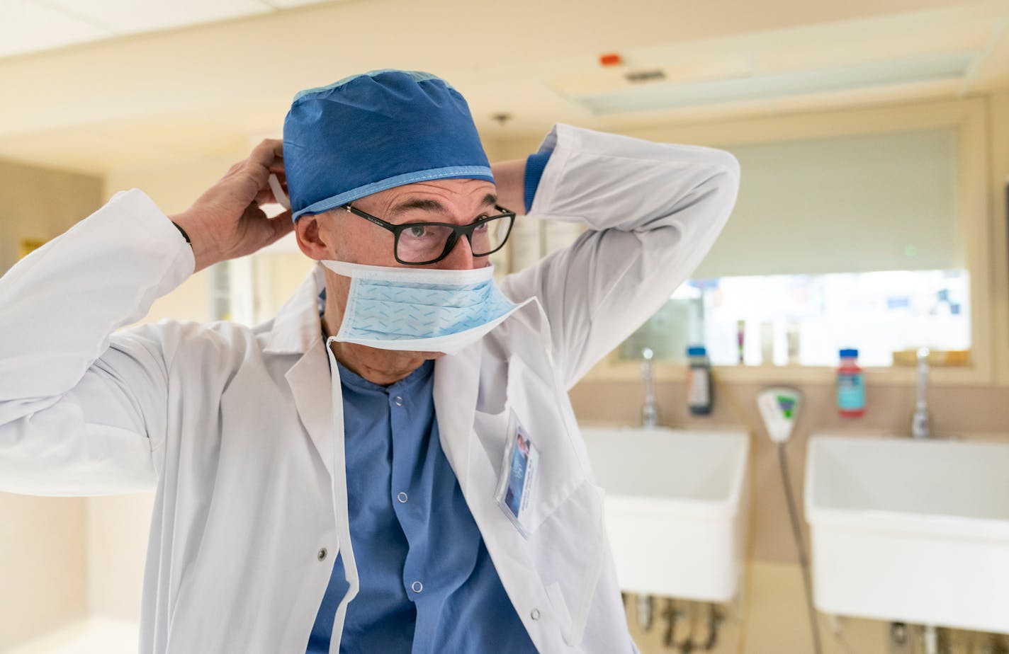 Dr. Gianrico Farrugia, the new president and CEO of Mayo Clinic, puts on a surgical mask to watch a vestibular stenosis repair surgery.