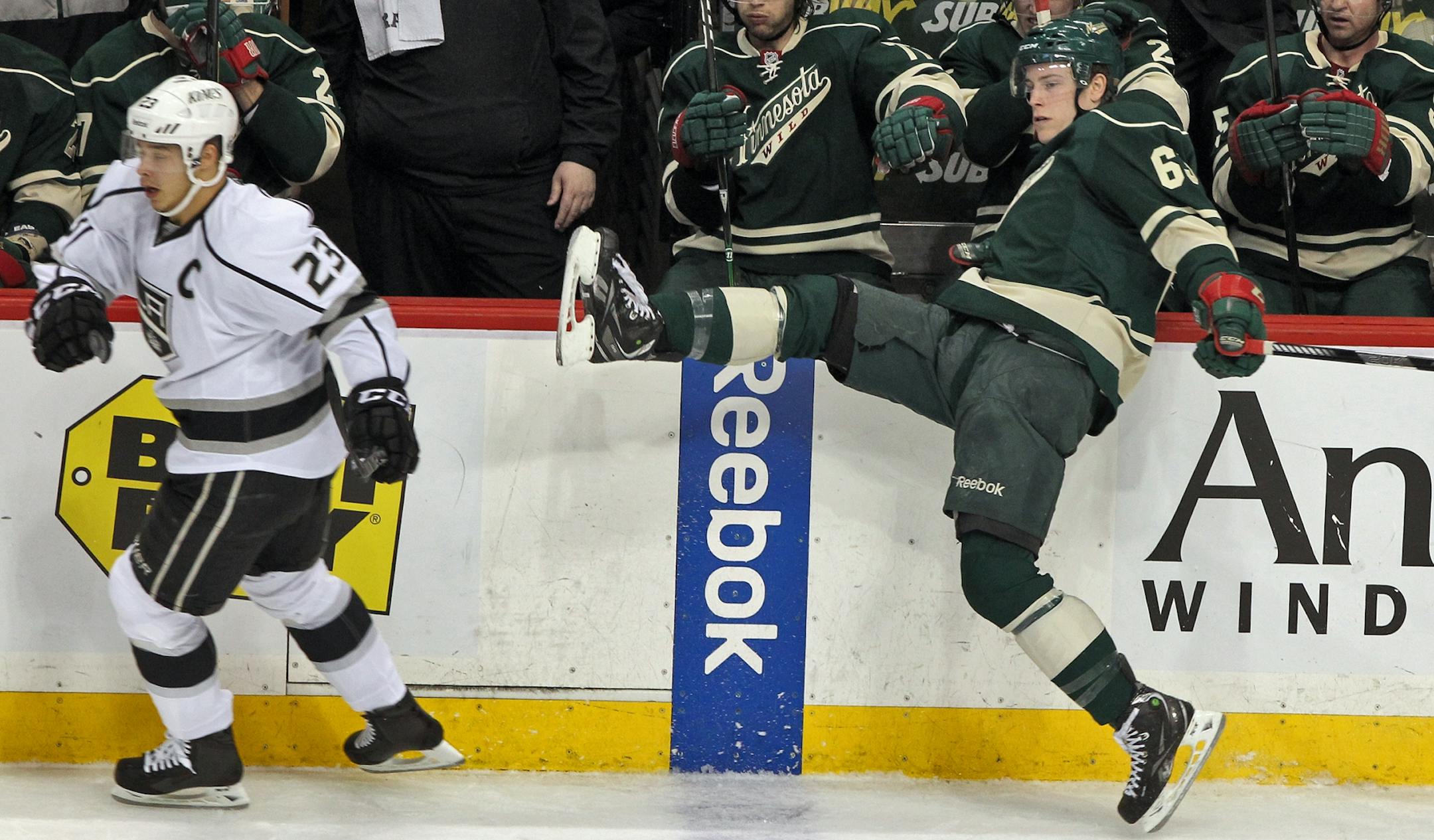 Los Angeles' Dustin Brown, left, checked the Wild's Charlie Coyle into the boards last season.