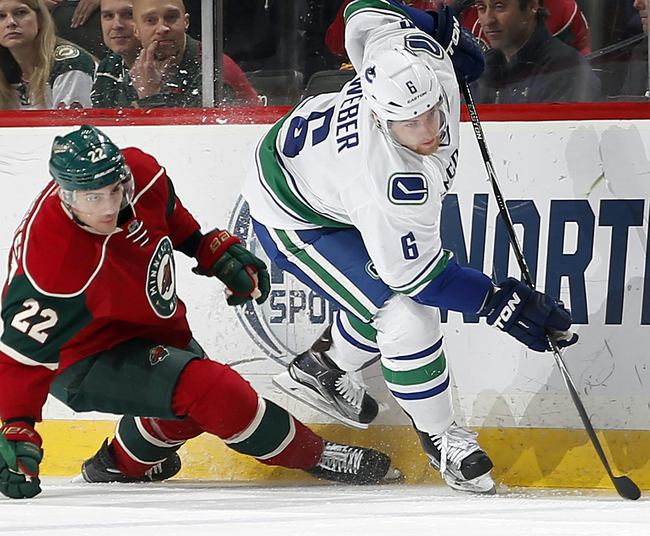 Nino Niederreiter (22) and Yannick Weber (6) fought for the puck in the first period. ] CARLOS GONZALEZ ï cgonzalez@startribune.com - December 15, 2015, St. Paul, MN, Xcel Energy Center, NHL, Minnesota Wild vs. Vancouver Canucks