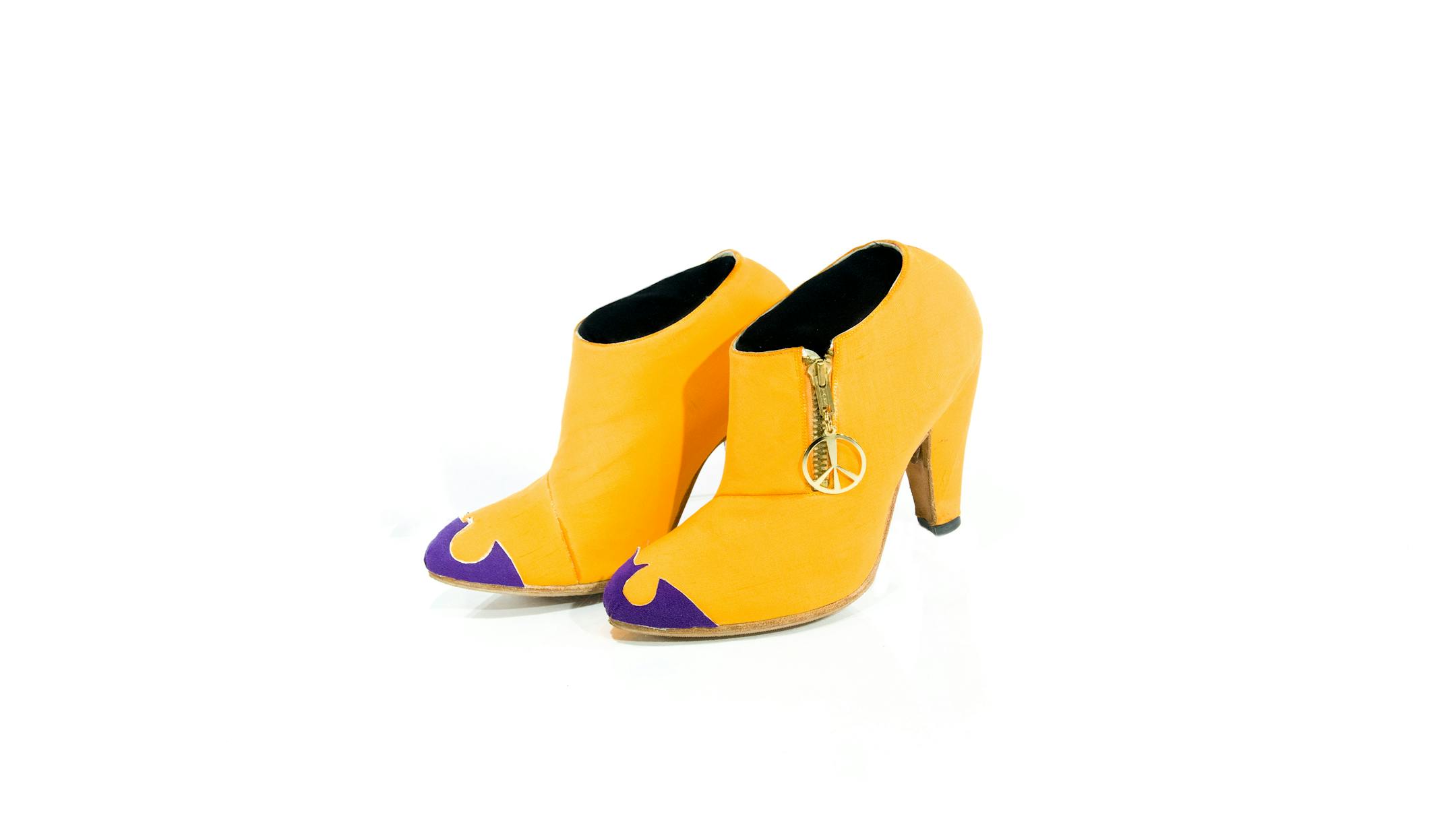 Following the wildly successful release of his 1989 Batman soundtrack album, most of Prince's shoes were in Joker colors (orange and purple) or Batman colors (black, gray and gold). Many pairs featured a Batman symbol on the toe, like this pair, which also sports a gold peace sign zipper pull.