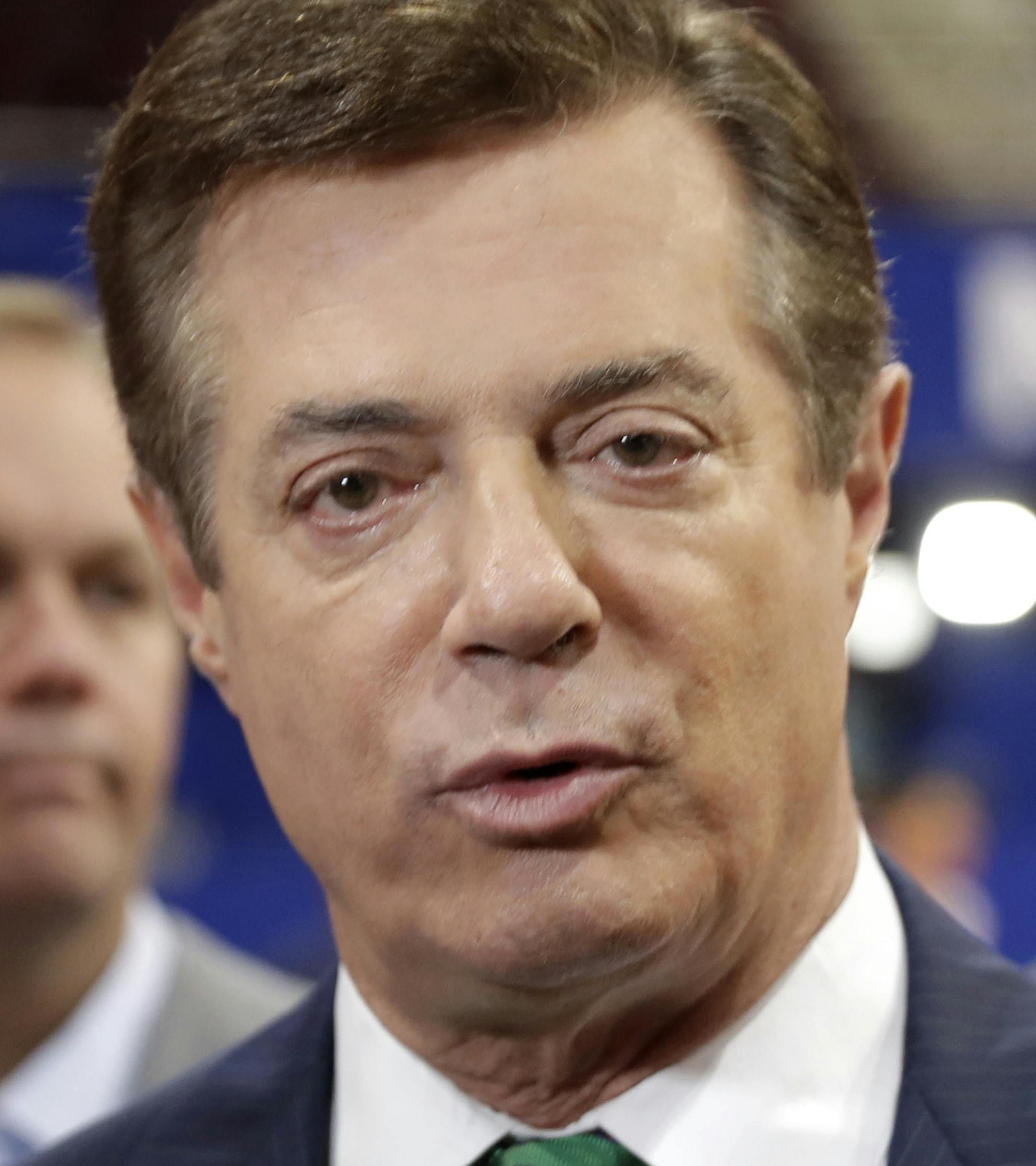 FILE - In this July 17, 2016 file photo, then-Donald Trump campaign chairman Paul Manafort talks to reporters on the floor of the Republican National Convention, in Cleveland. Manafort, President Donald Trump's former campaign chairman, has registered with the Justice Department as a foreign agent for political consulting work he did for a Ukrainian political party, acknowledging he coached party members on how to interact with U.S. government officials. (AP Photo/Matt Rourke, File)