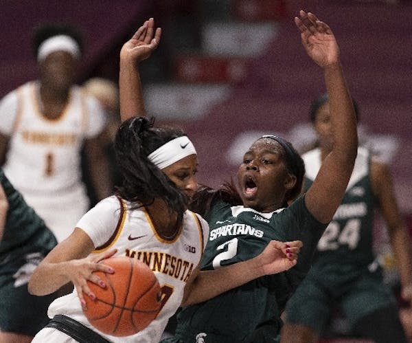 Gophers forward Kadi Sissoko earned a charging foul by driving into Michigan State forward Mardrekia Cook (2) in the first quarter Wednesday night.