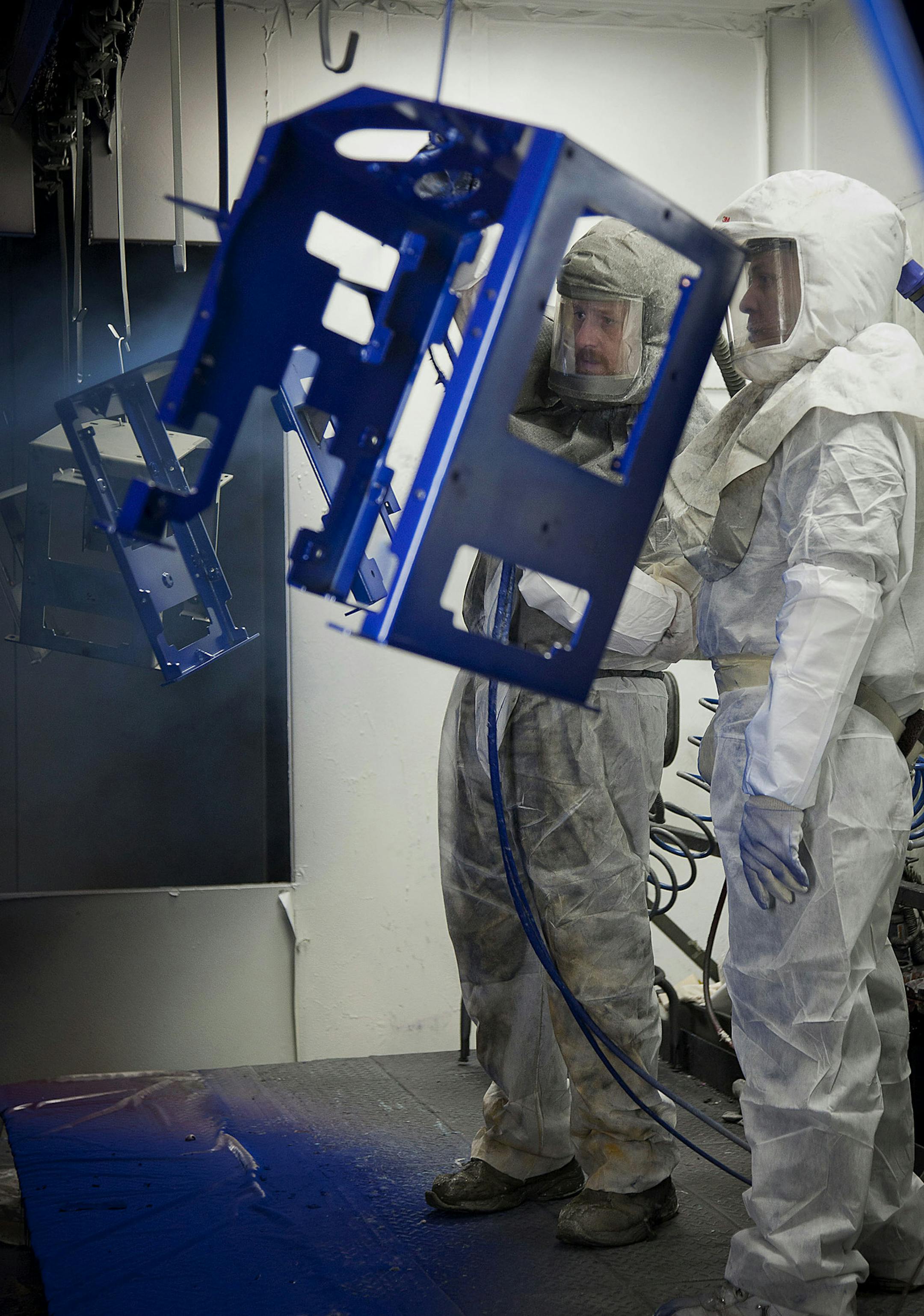 Employee Joe Stelflug, left, and trainee Dwane Whekins paint chassis at the Graco Inc. manufacturing facility in Minneapolis, Minnesota, U.S., on Tuesday, Feb. 5, 2013. The U.S. Federal Reserve is scheduled to release manufacturing production figures on Feb. 15. Photographer: Ariana Lindquist/Bloomberg *** Local Caption *** Joe Stelflug; Dwane Whekins ORG XMIT: 161819514