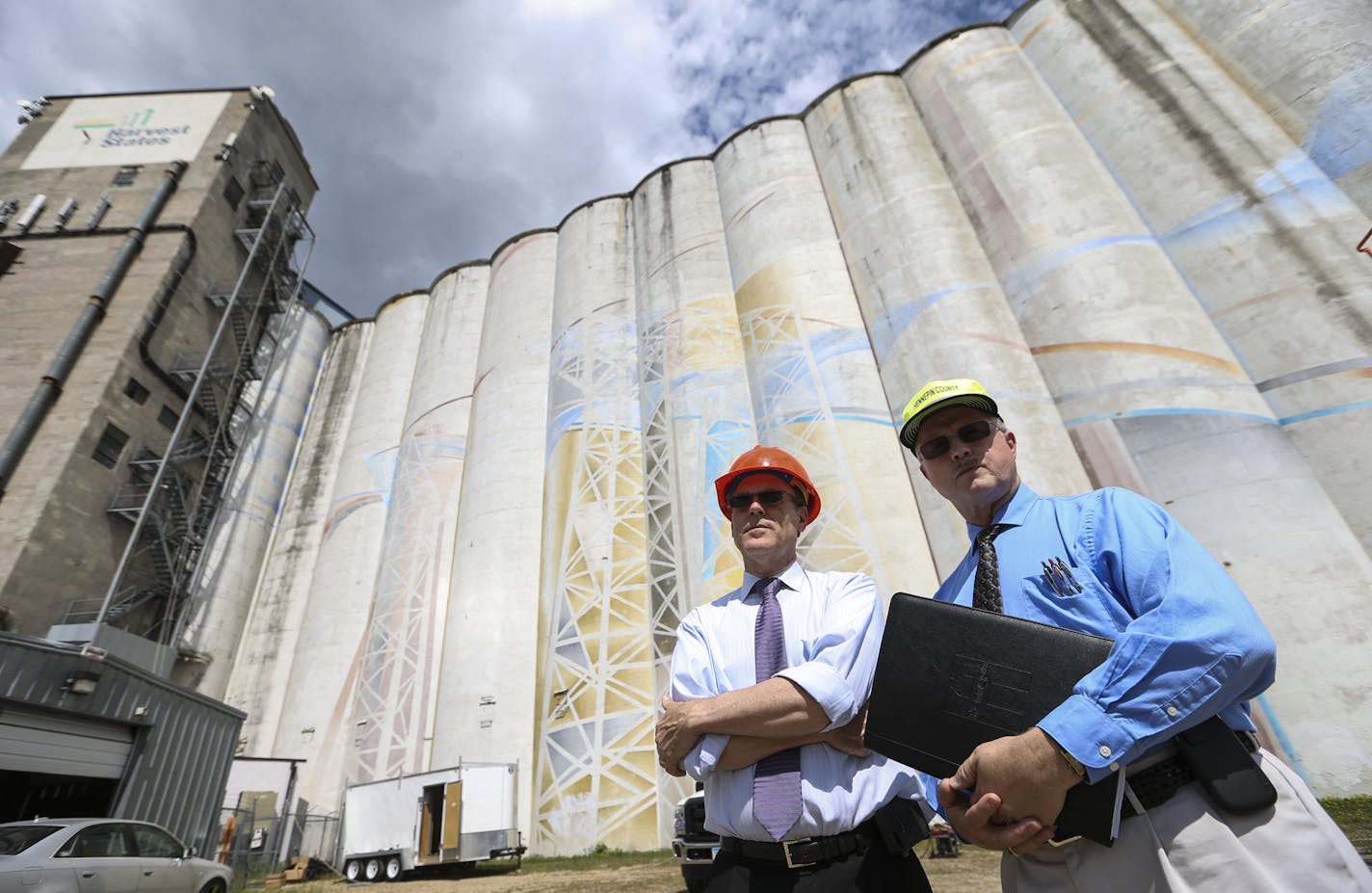 Mark Chapin, Hennepin County's director of taxpayer services, county auditor and county treasurer, and administrative manager Jeff Strand posed for a picture next to the giant abandoned grain elevators on Hiawatha that the city just got back in tax forfeiture on Wednesday, July 23, 2014, in Minneapolis, Minn. ] RENEE JONES SCHNEIDER &#x2022; reneejones@startribune.com ORG XMIT: MIN1407232154050861