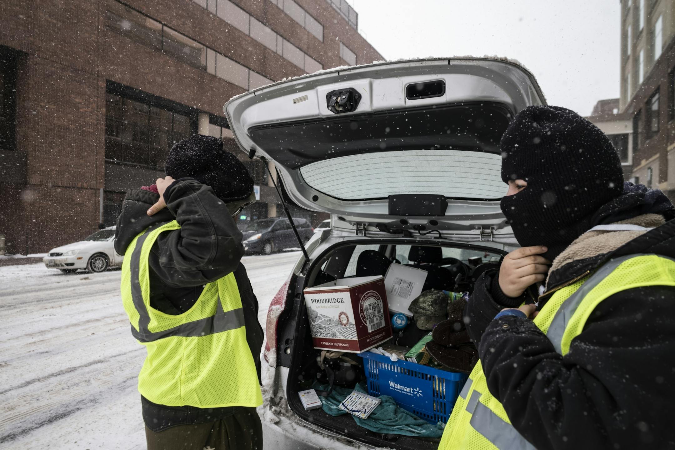 Carol Thicke, left, and Taysha Martinleau, right, of Fond du Lac Reservation, got dressed for the cold before handing out fliers around downtown Duluth.