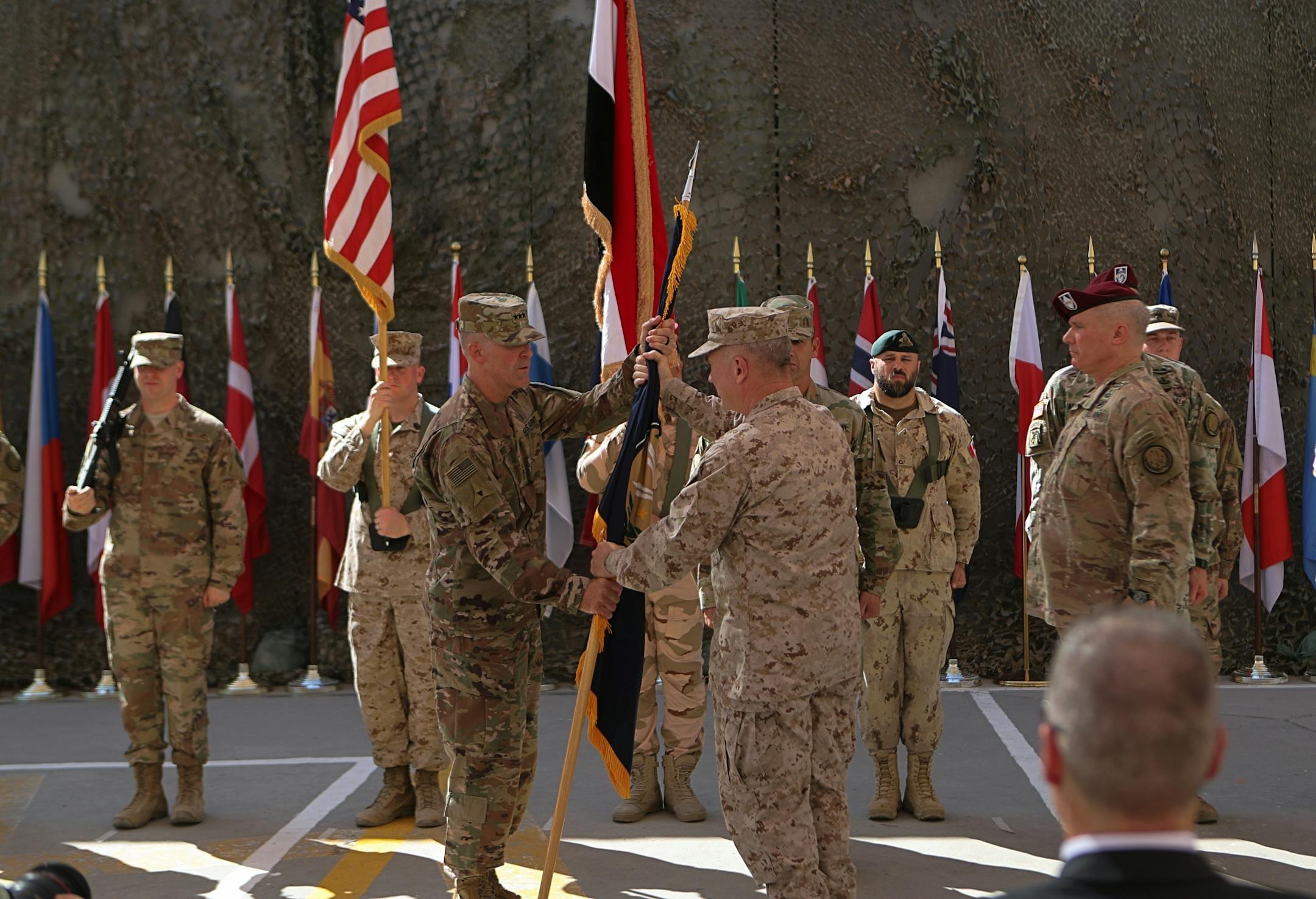 In this Sept. 14, 2019, photo U.S. Army Lt. Gen. Pat White, III Armored Corps Commanding General, center left, and Commanding General for U.S. Central Command Gen. Kenneth F. McKenzie Jr. center right, take part in a transfer authority ceremony at Union III, base in Baghdad, Iraq, Saturday, Sept. 14, 2019. White is the Fort Hood commander and he is facing the grim task of rebuilding trust and turning around an installation that has one of the highest rates of murder, sexual assault and harassmen